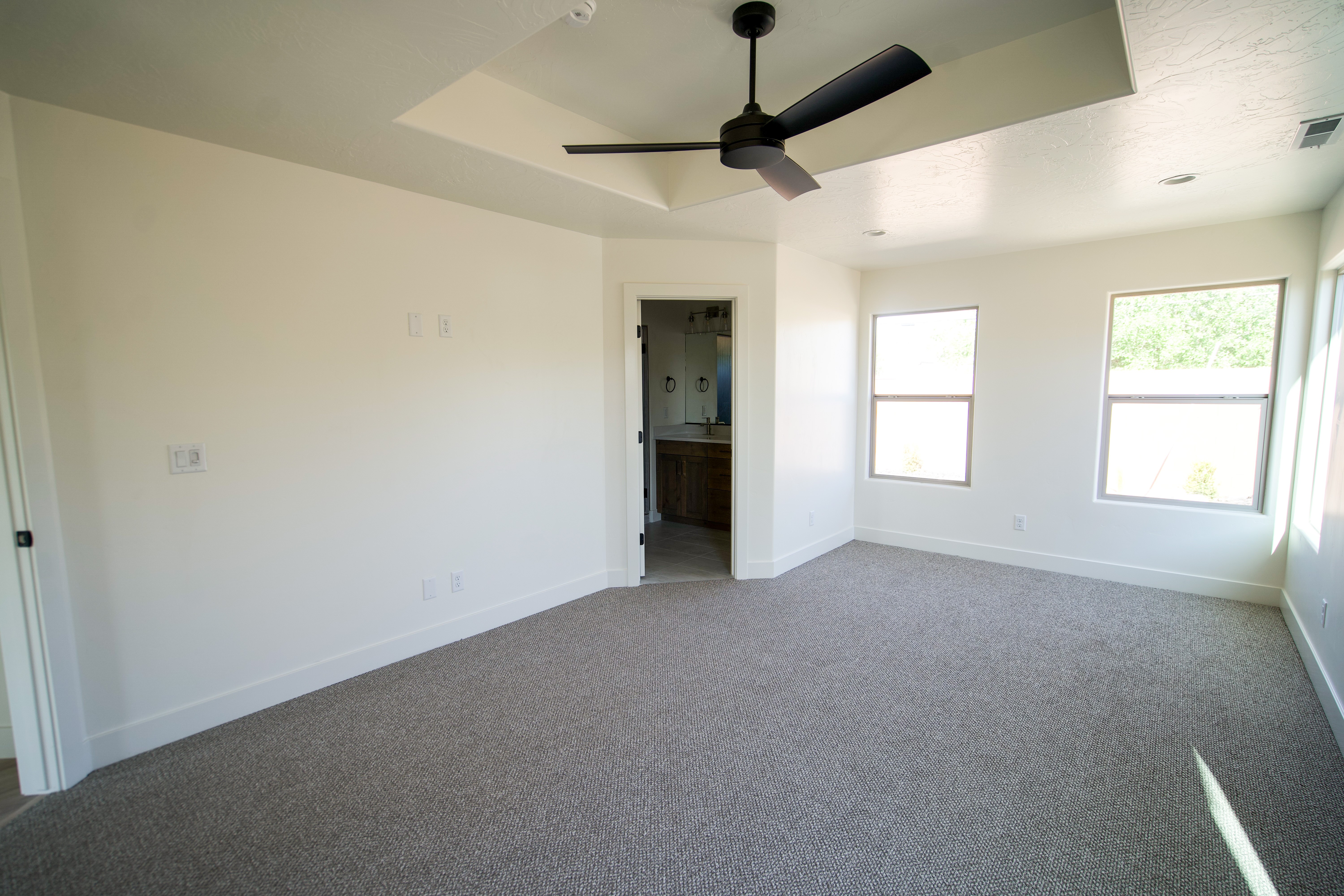 Primary bedroom in a Southern Utah remodel featuring light and airy aesthetic.