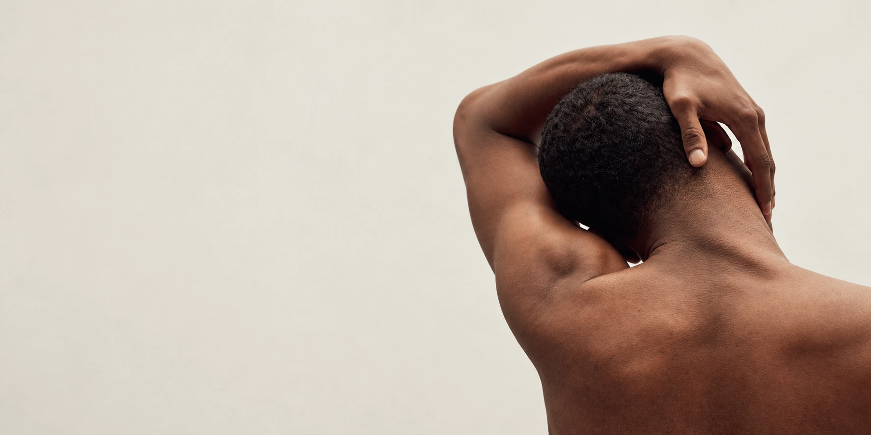 A man taking a gentle shoulder and neck stretch break