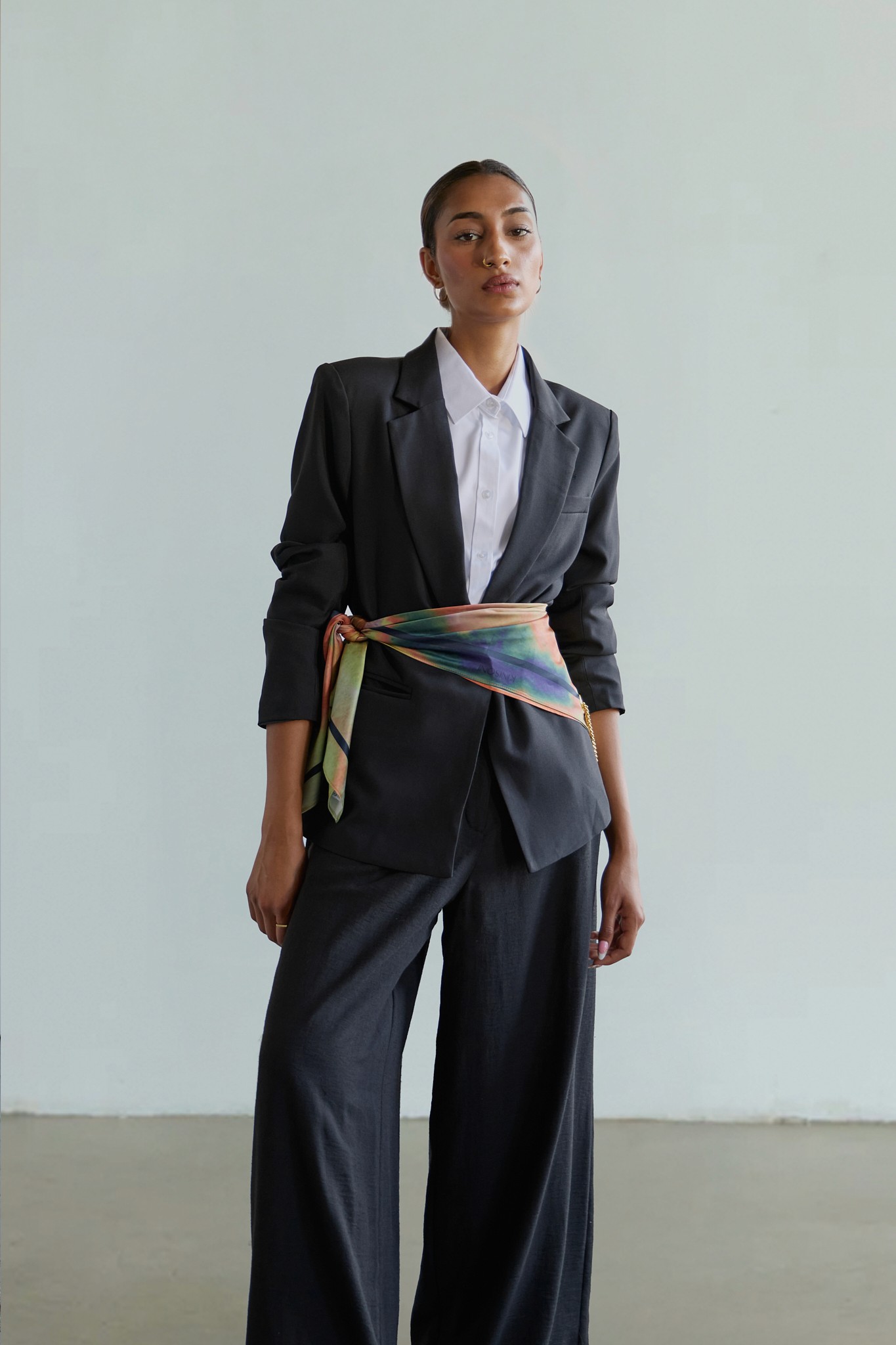 Young woman with dark hair and bangs, wearing red.