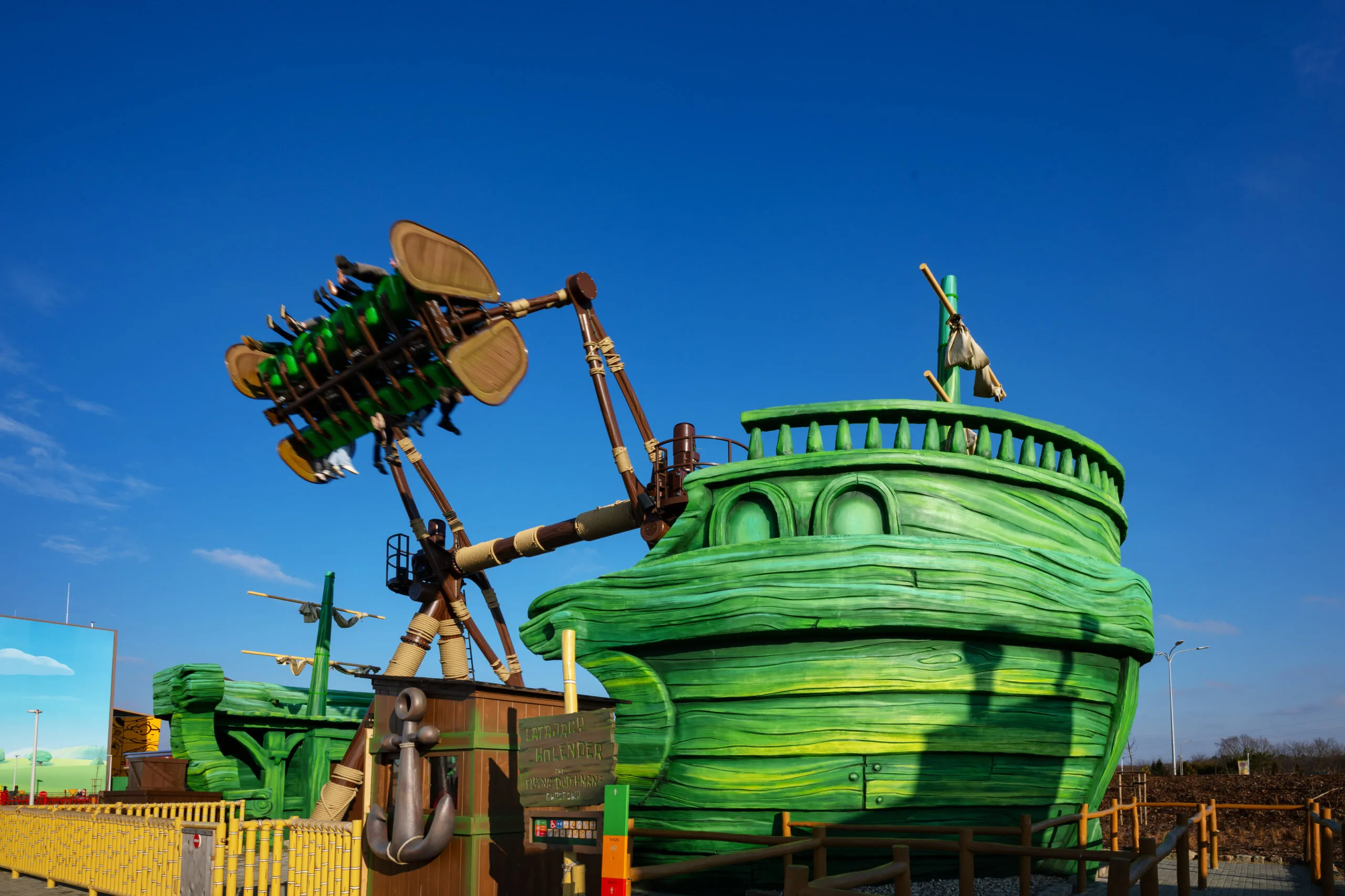 forced-perspective photography of green dinosaur figurine