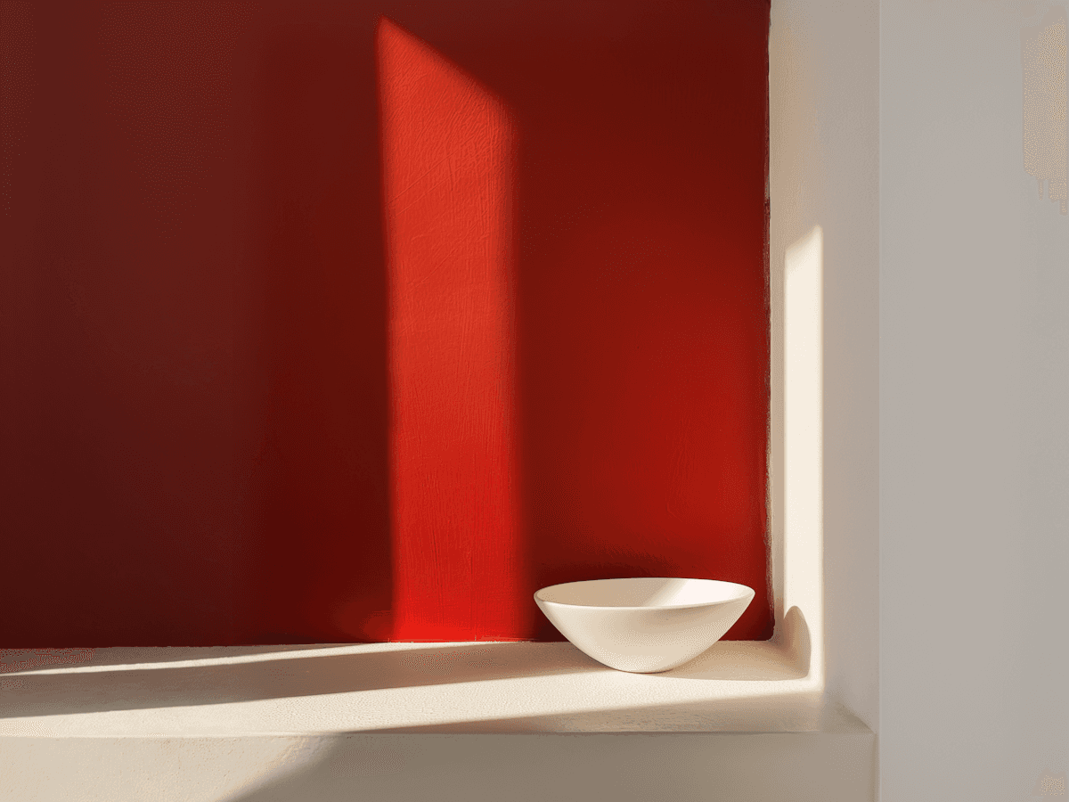Minimalist Composition with White Bowl and Red Backdrop