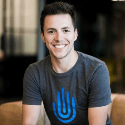 Professional headshot of smiling team member wearing Trinsic branded t-shirt