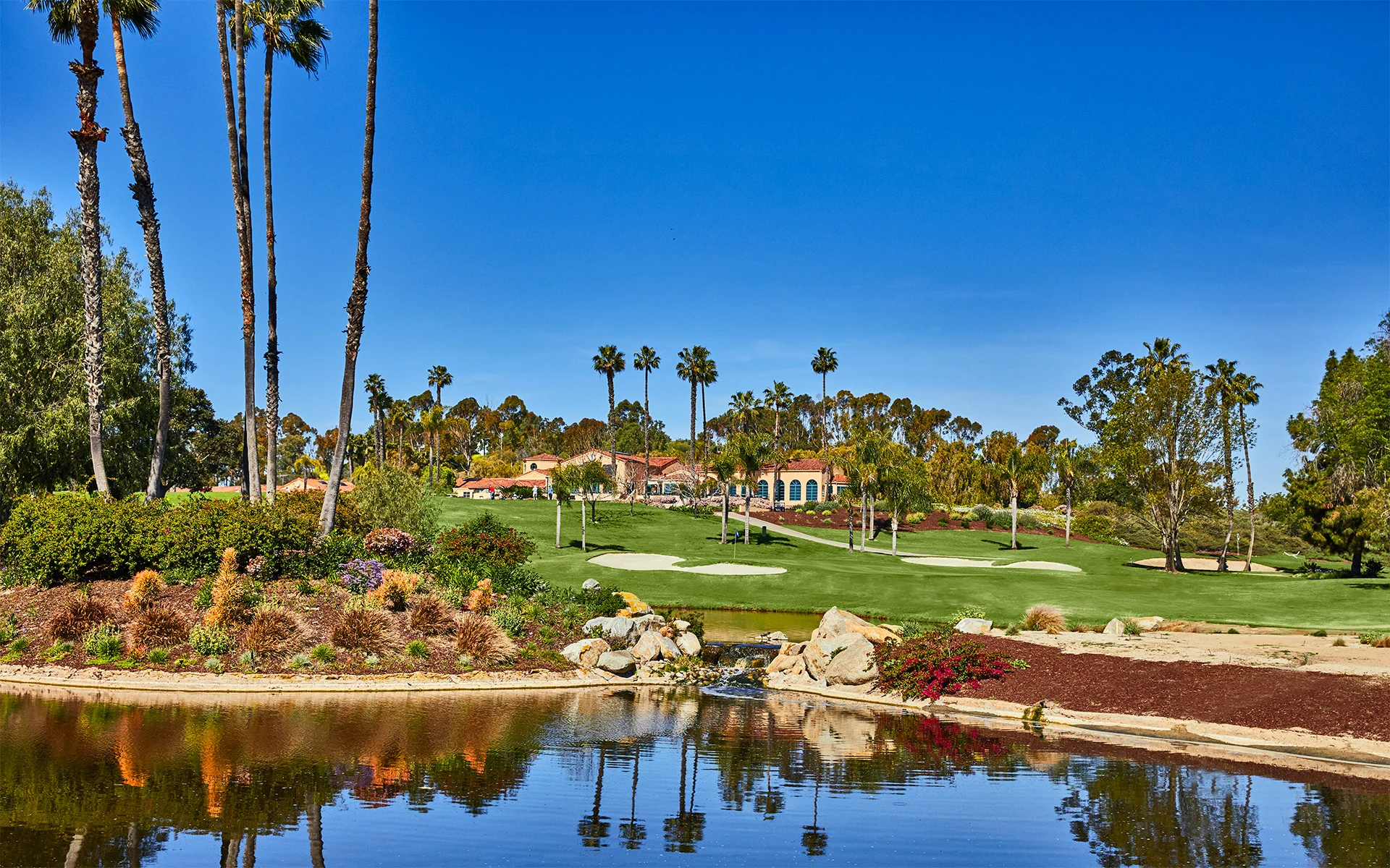 Front view of golf course with a water hazard in the foreground