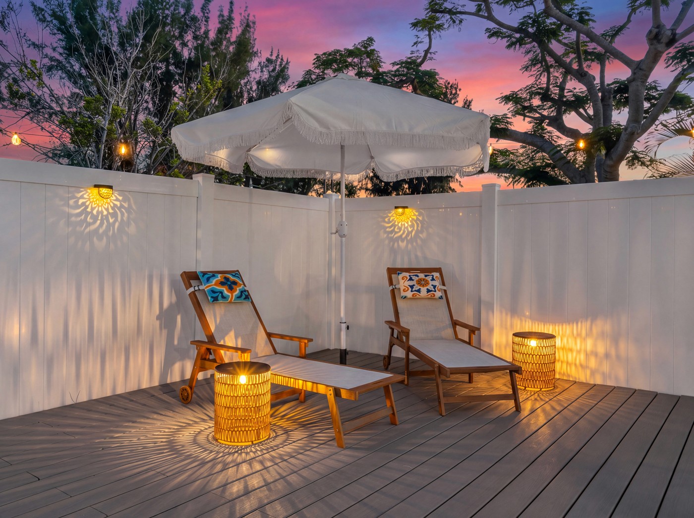 Private outdoor lounge with chaise seating and ambient lighting photographed at sunset at an Anna Maria Island vacation rental