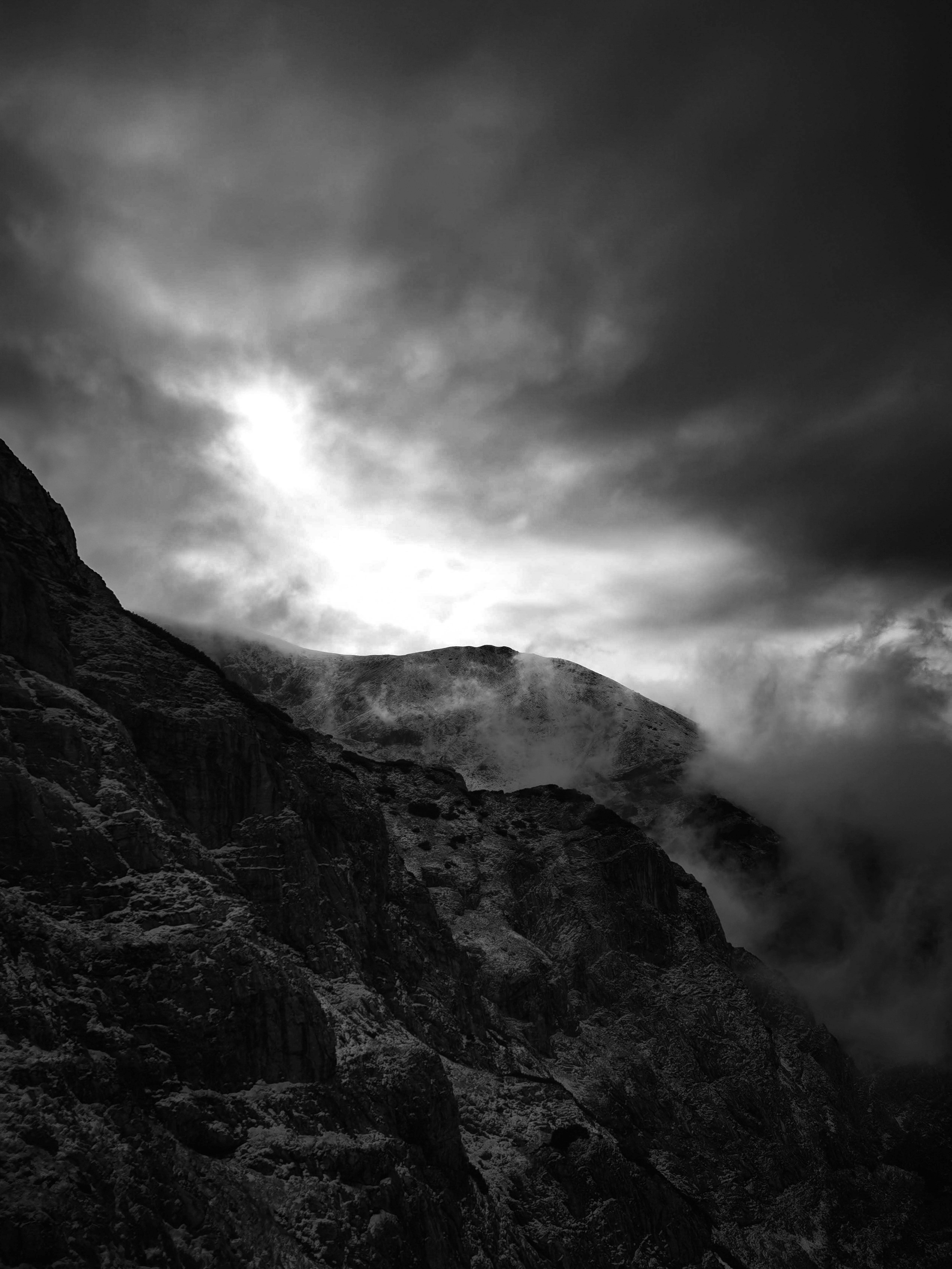 Person sitting on a ledge overlooking New York City skyline