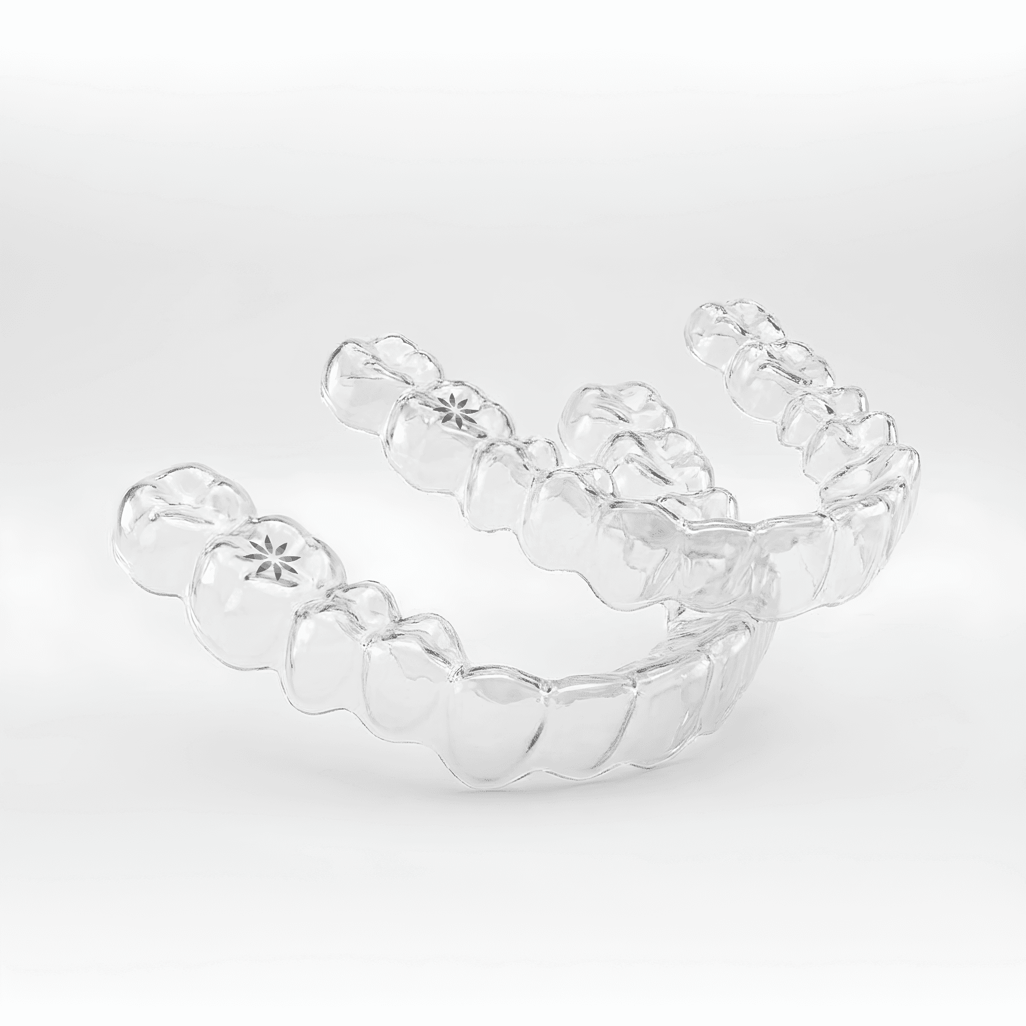 Invisalign in Dubai with a woman smiling confidently, holding her clear aligners, highlighting discreet and effective treatment.