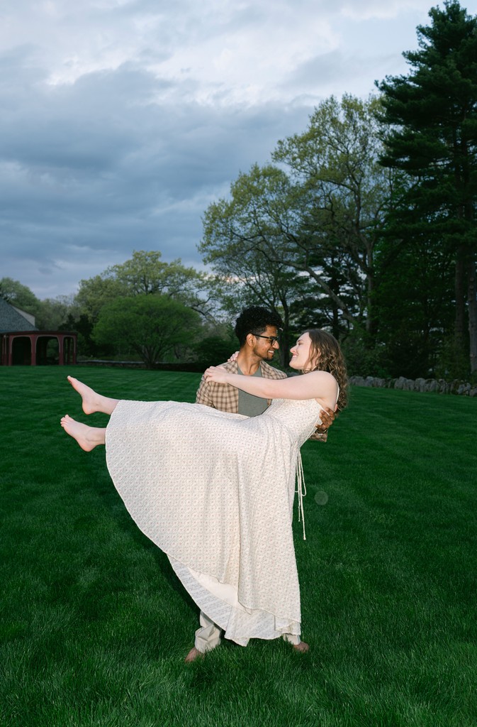 Couple portrait with dog on field