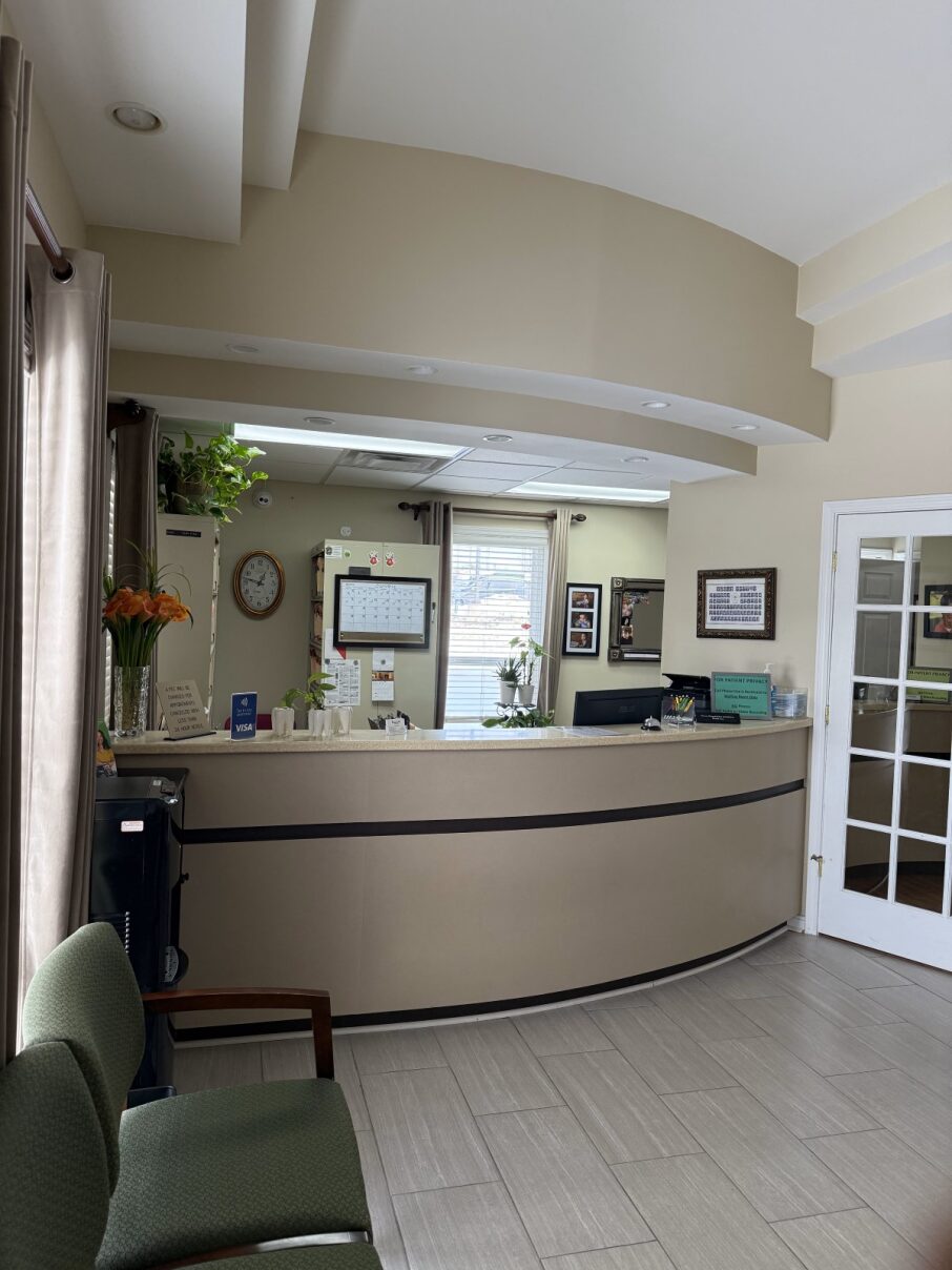 Modern dental office reception desk and patient lobby area featuring a clean, welcoming atmosphere.