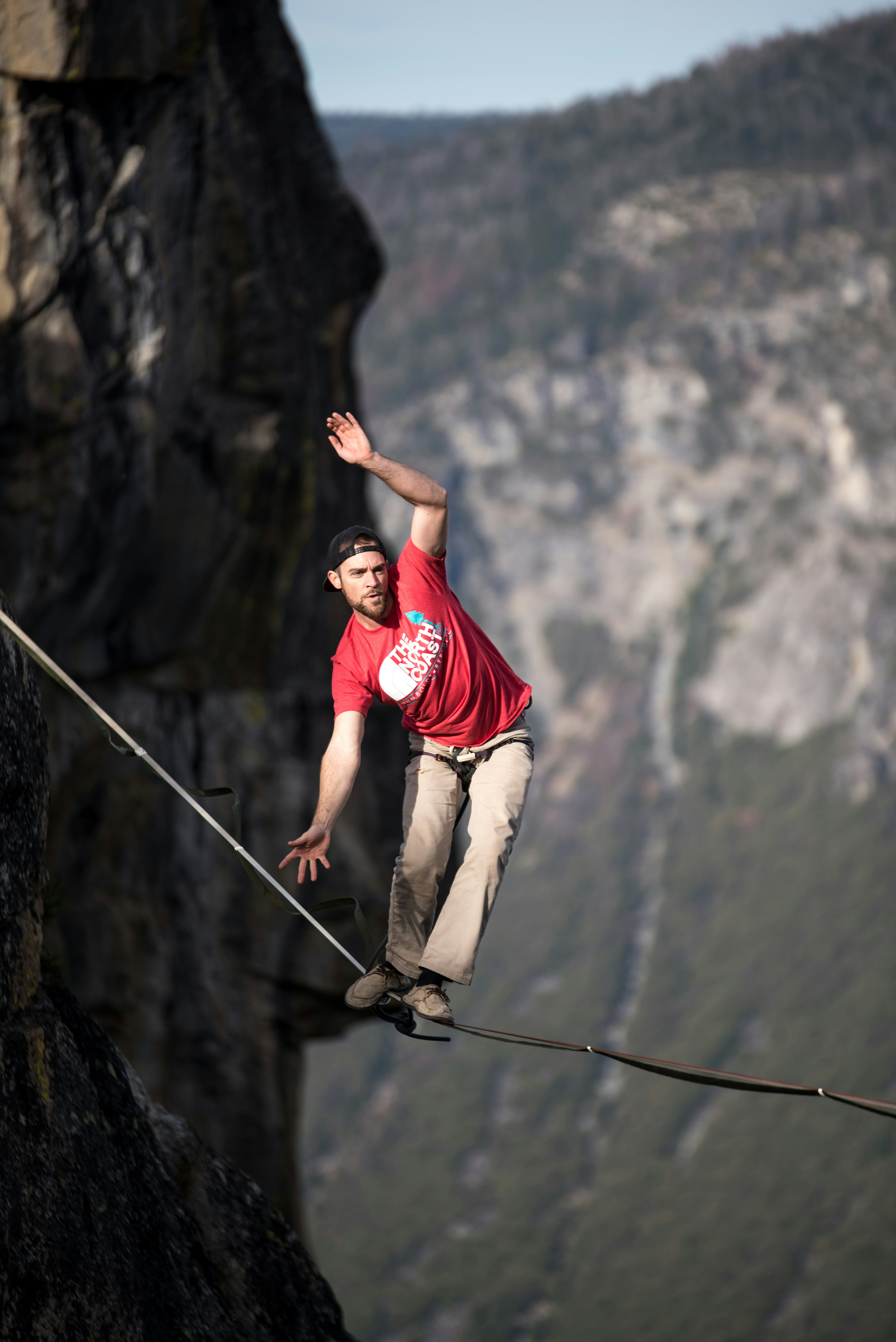 Man on high altitude crossing a rope