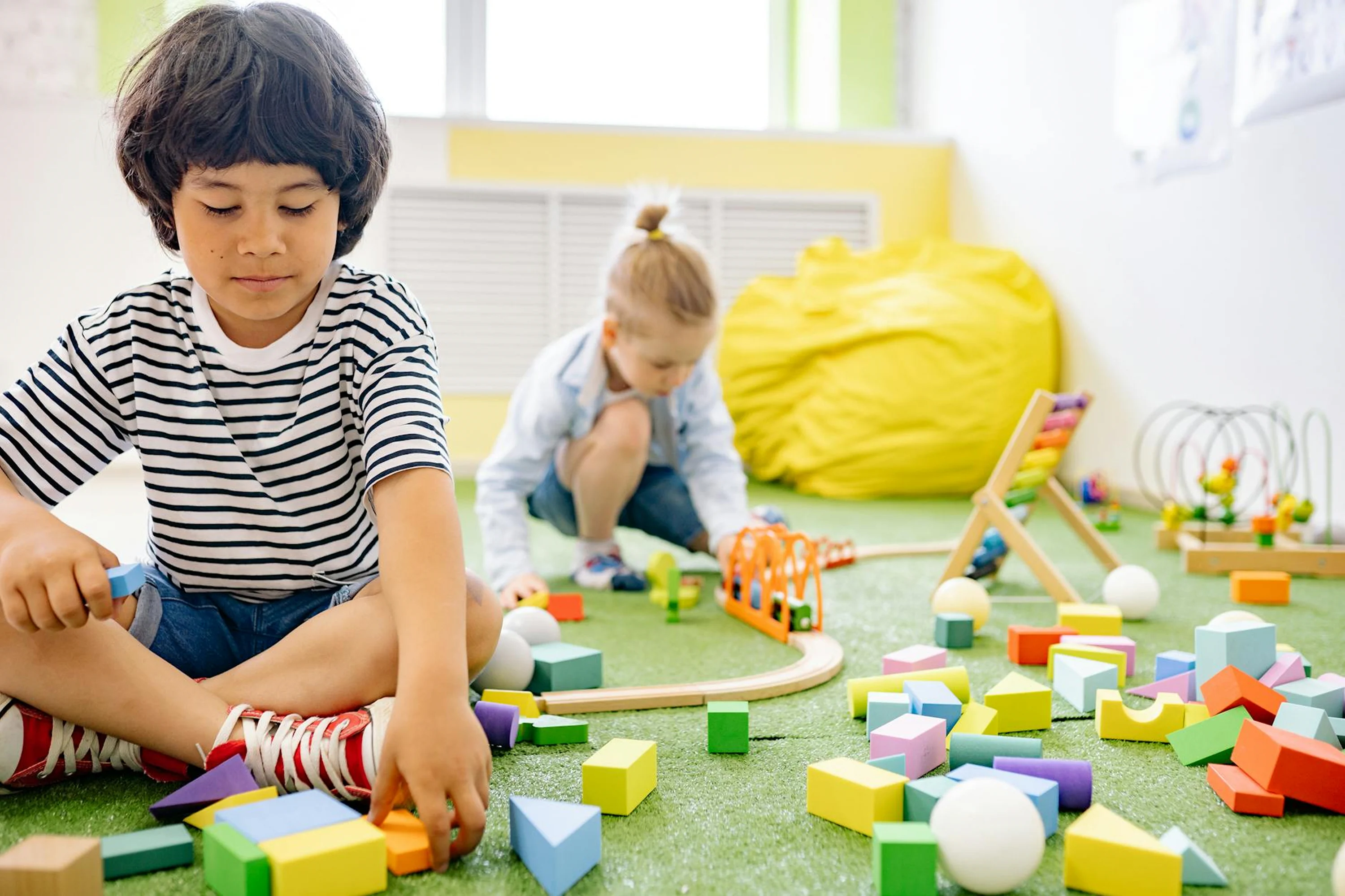 Children learning through block play in a bright preschool classroom.