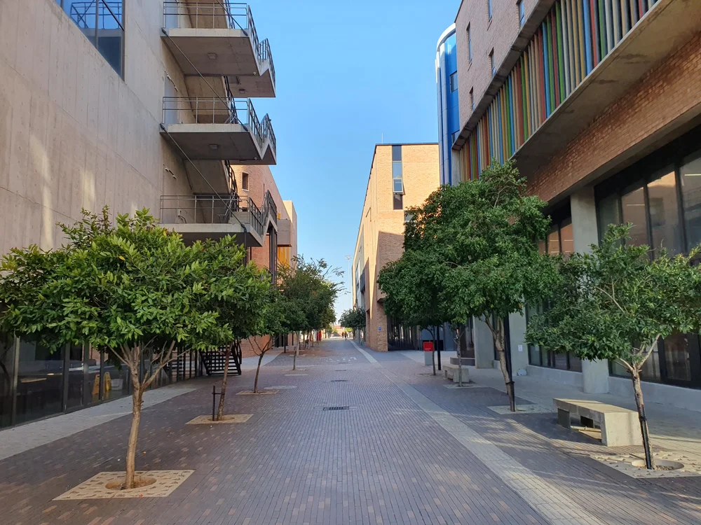 Close-up of a sleek modern electronic device with a magnetic connector and an orange logo on a metallic surface.