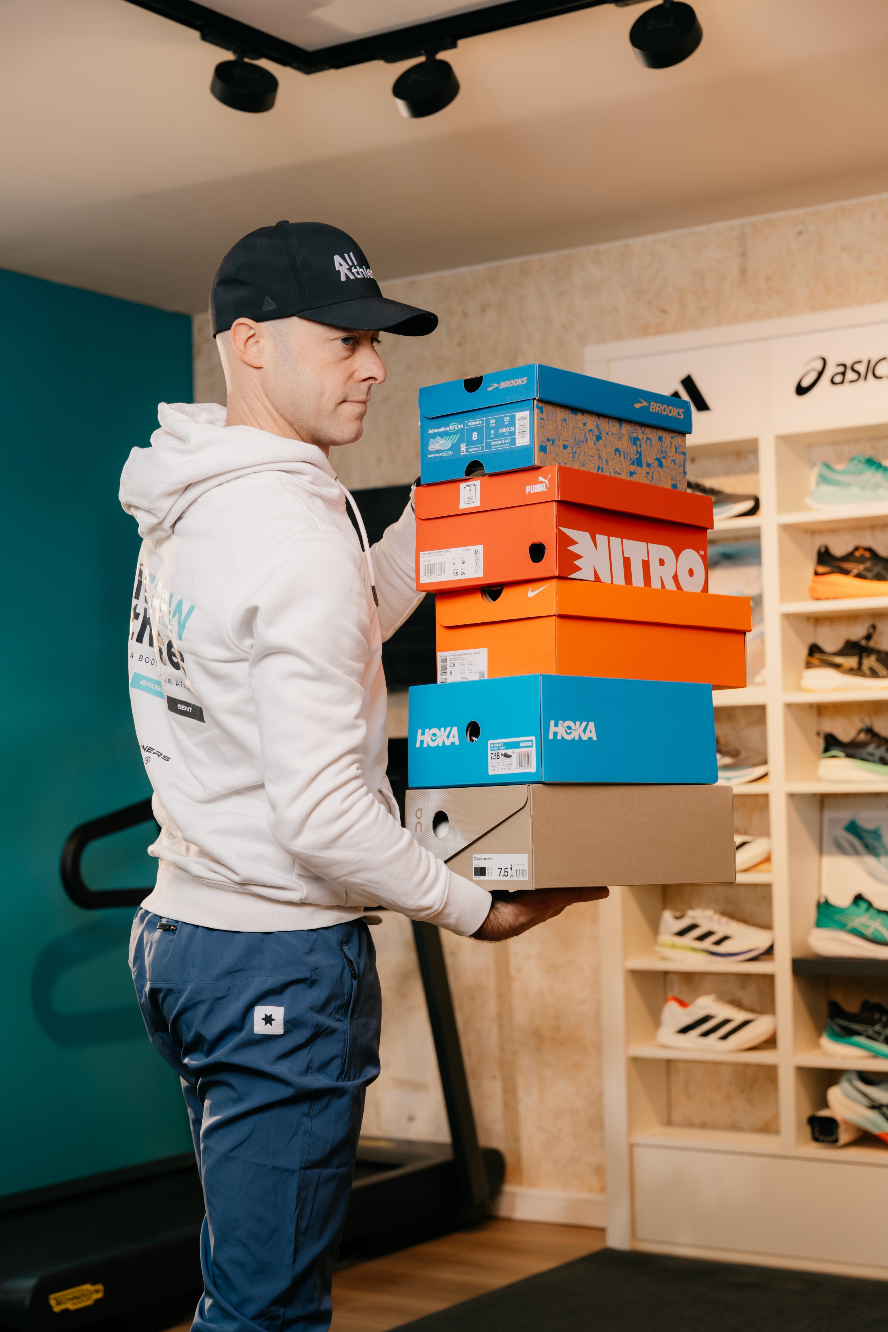 Four diverse professionals collaboratively working on a laptop, with one person pointing at the screen while others observe.