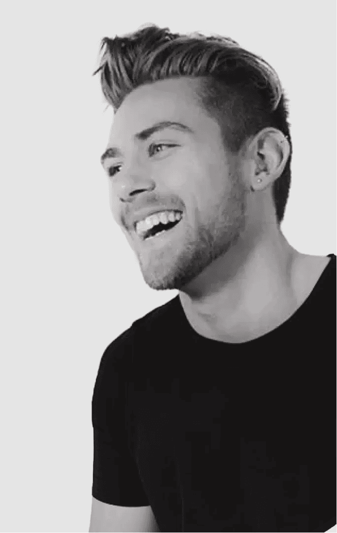Black and white portrait of a smiling person with curly hair