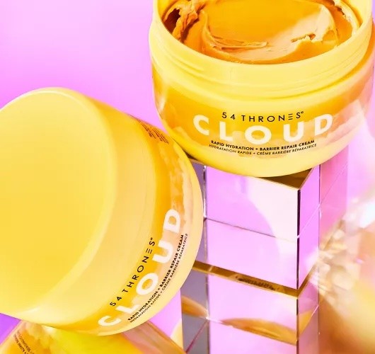 Detail shot of the Cloud Cream packaging — showcasing the bright yellow jar, clean typography, and smooth product texture.