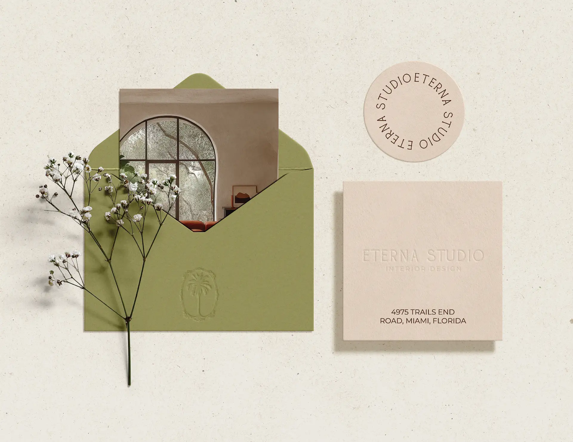 Brand collateral design for Eterna Studio interior design showing branded envelope, business card and circular stamp