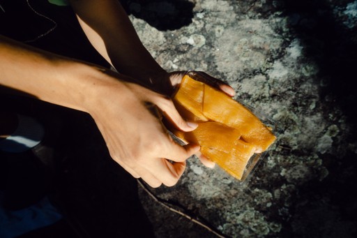 Traditional hoshi imo on a plate in the foreground, sweet potatoes in the background
