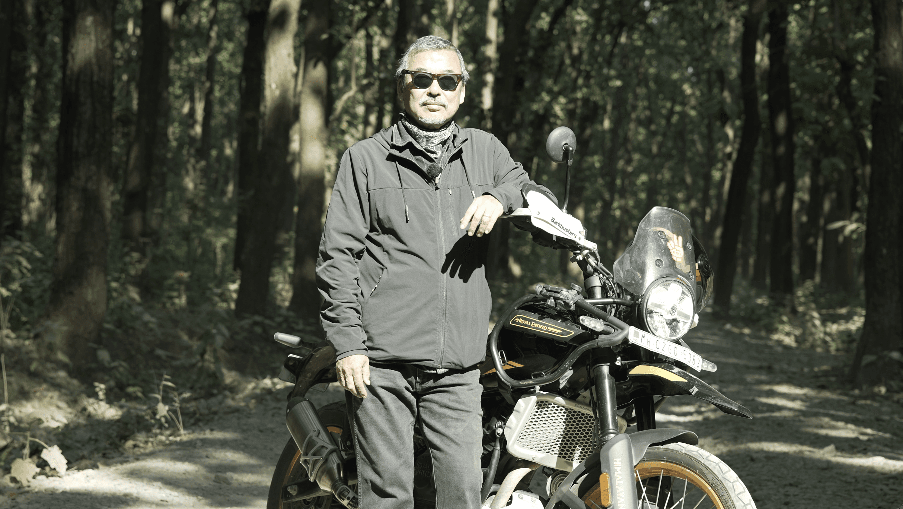Black-and-white photo of a guitarist playing in a small venue, surrounded by the crowd.