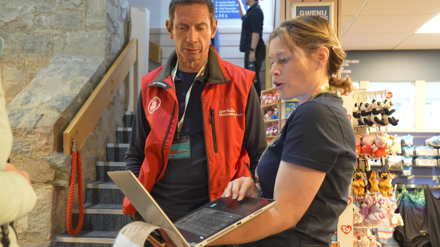 booking staff look at a laptop in an office