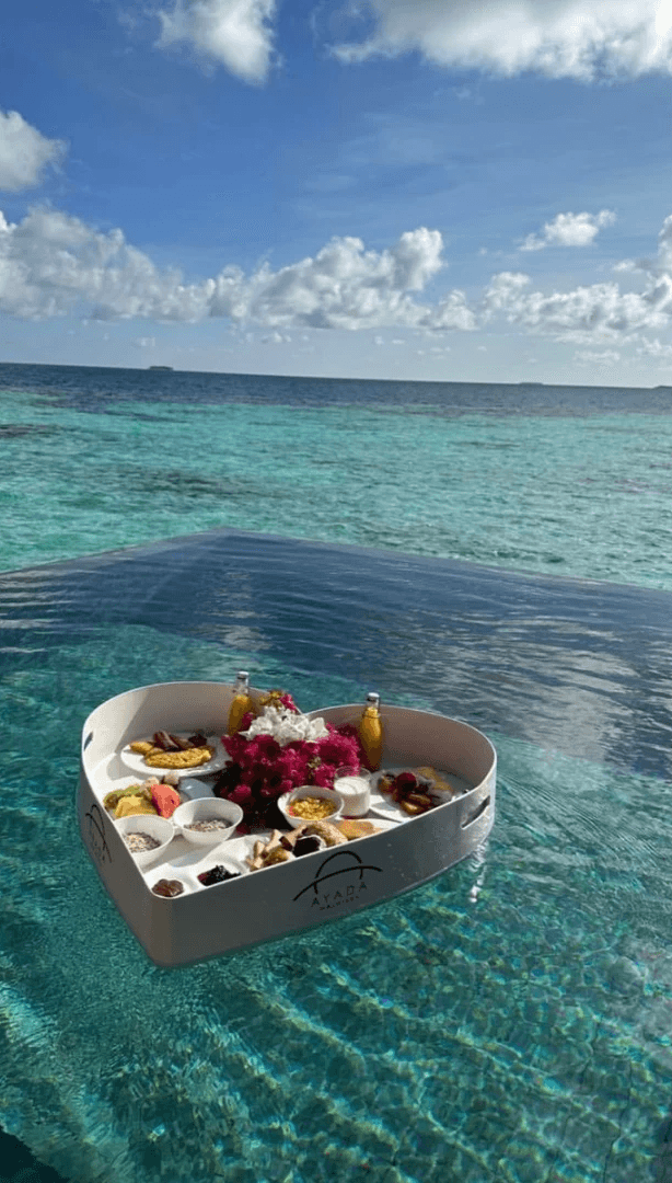 silver-colored ring on top of red roses