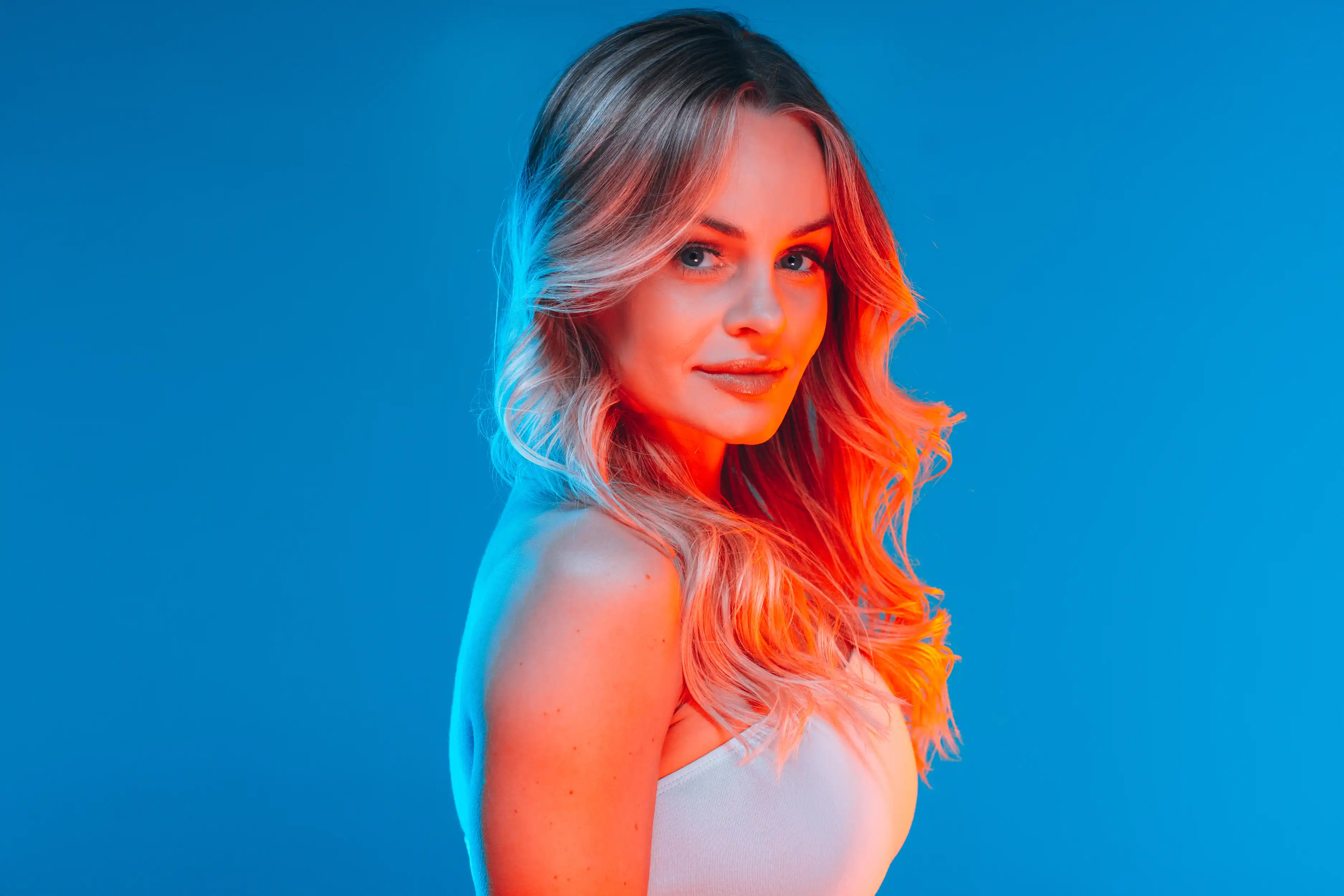 Tampa studio personal branding portrait of multi-company founder Carly R. with bold blue and orange lighting.