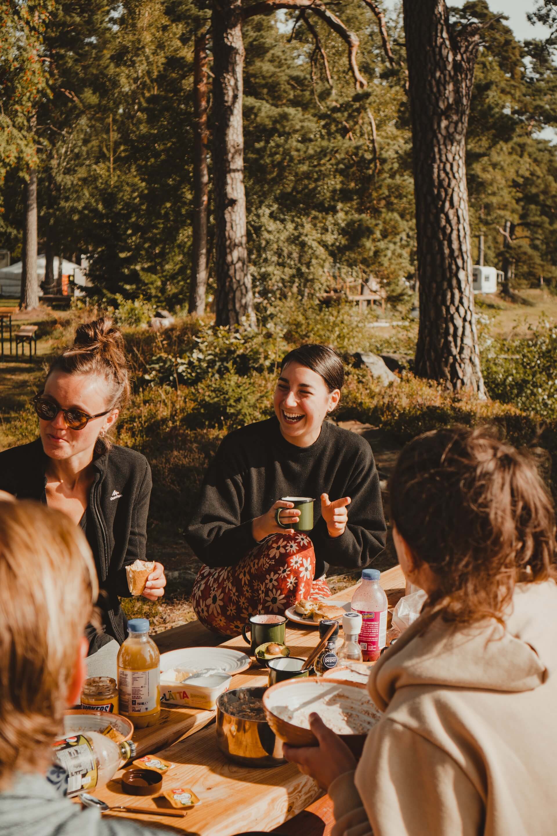 Friends take breakfast in a camp