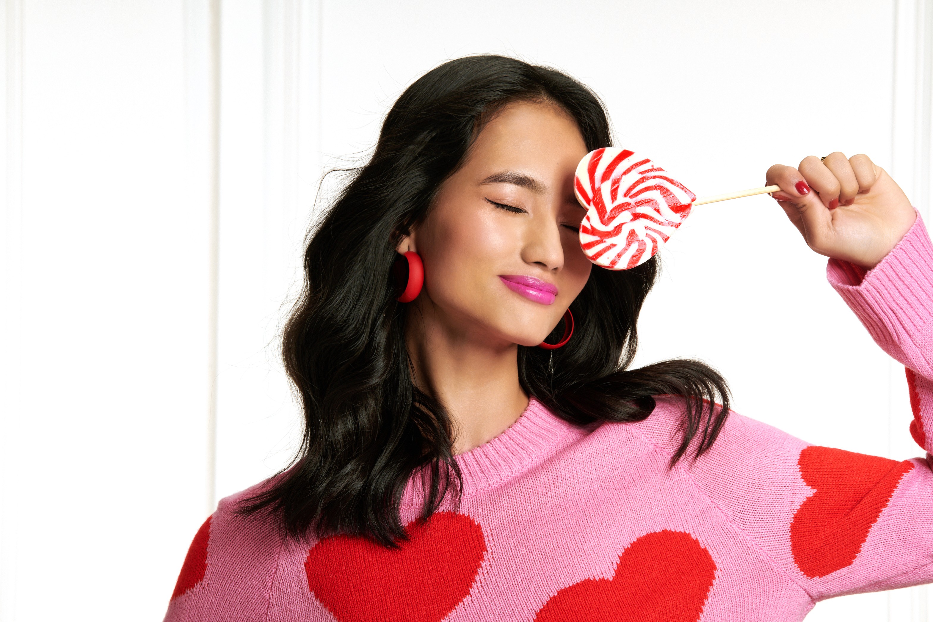 Person sitting on a ledge overlooking New York City skyline