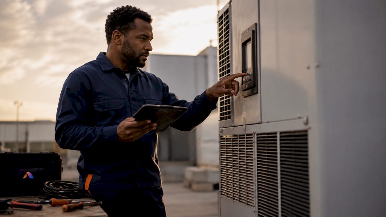 Facility manager inspecting HVAC with tablet