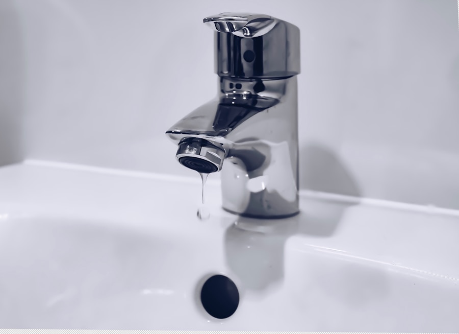 Chrome faucet dripping into a sink