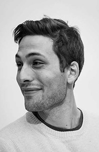 A black and white photo of a man wearing a blause.