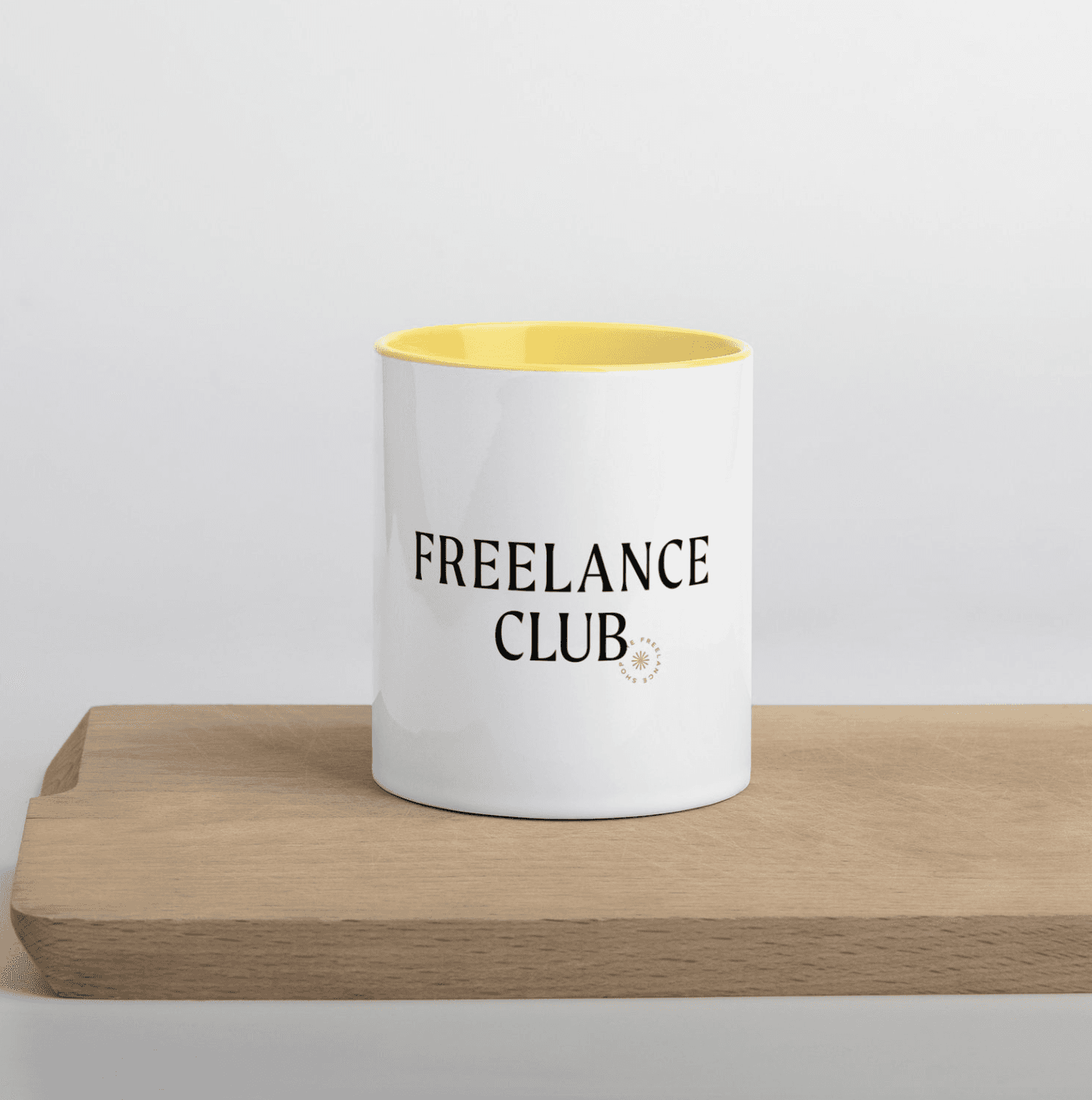 photo of a mug that says "freelance club" and it has a yellow interior