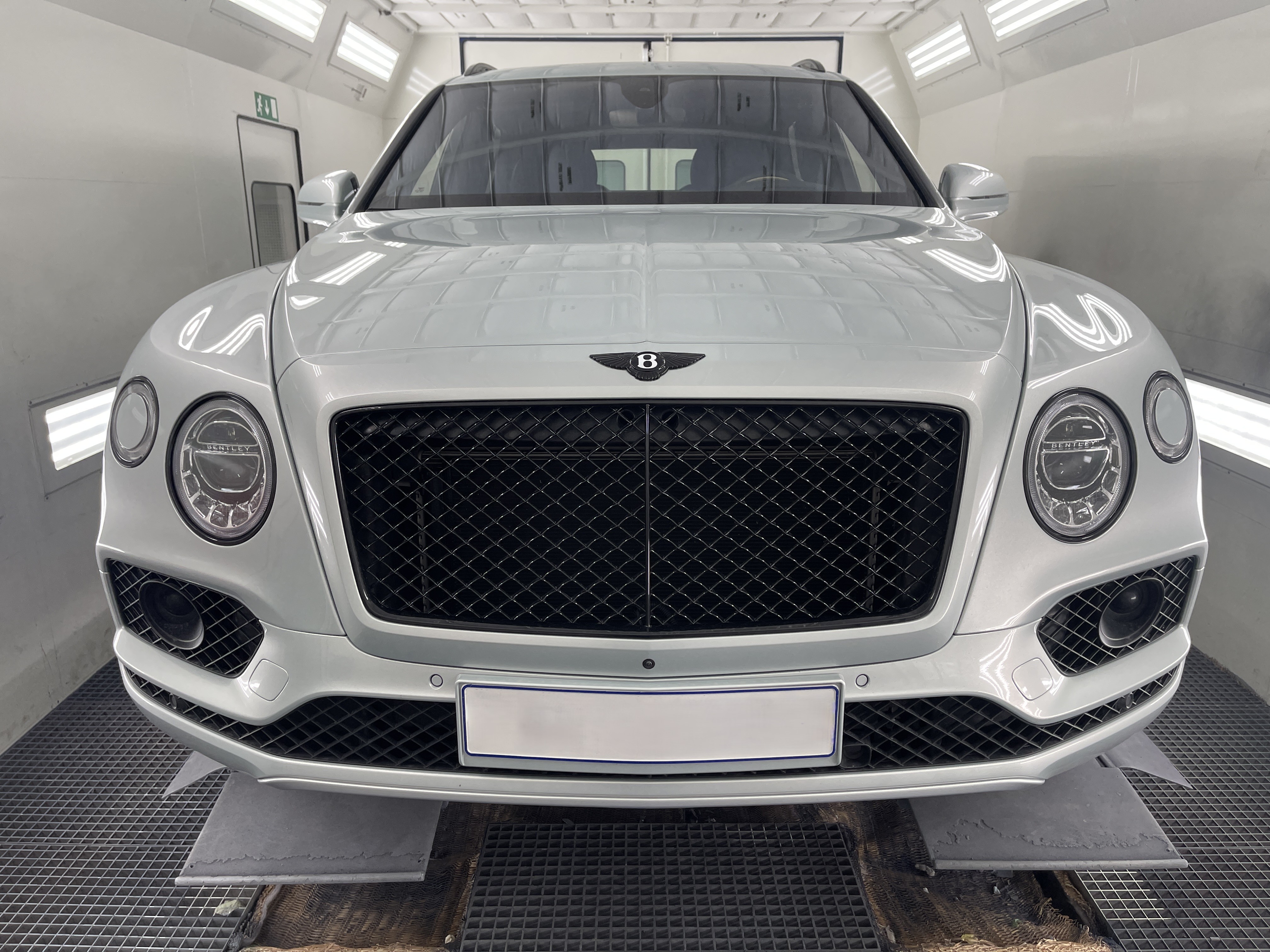a man waxing the hood of a car