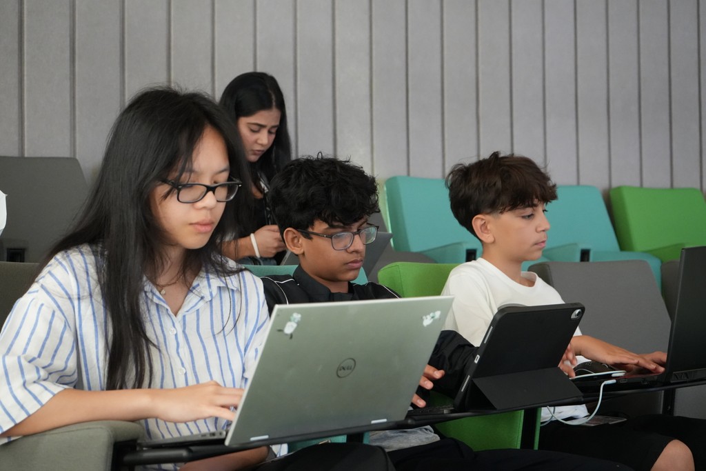 Smiling high school girl engaged in an online tutoring session with her peers at Rise Research