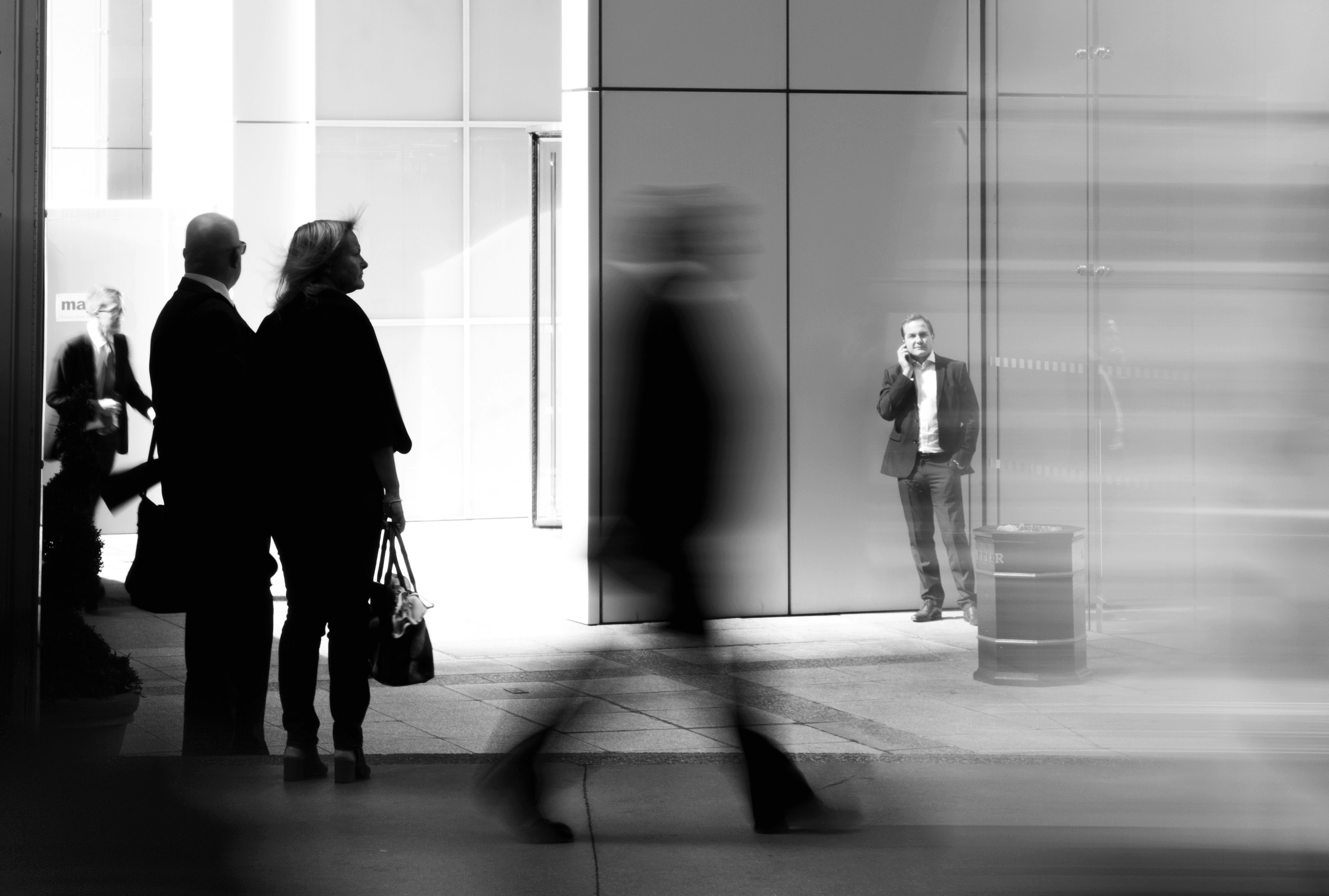 grayscale photo of people walking towards building
