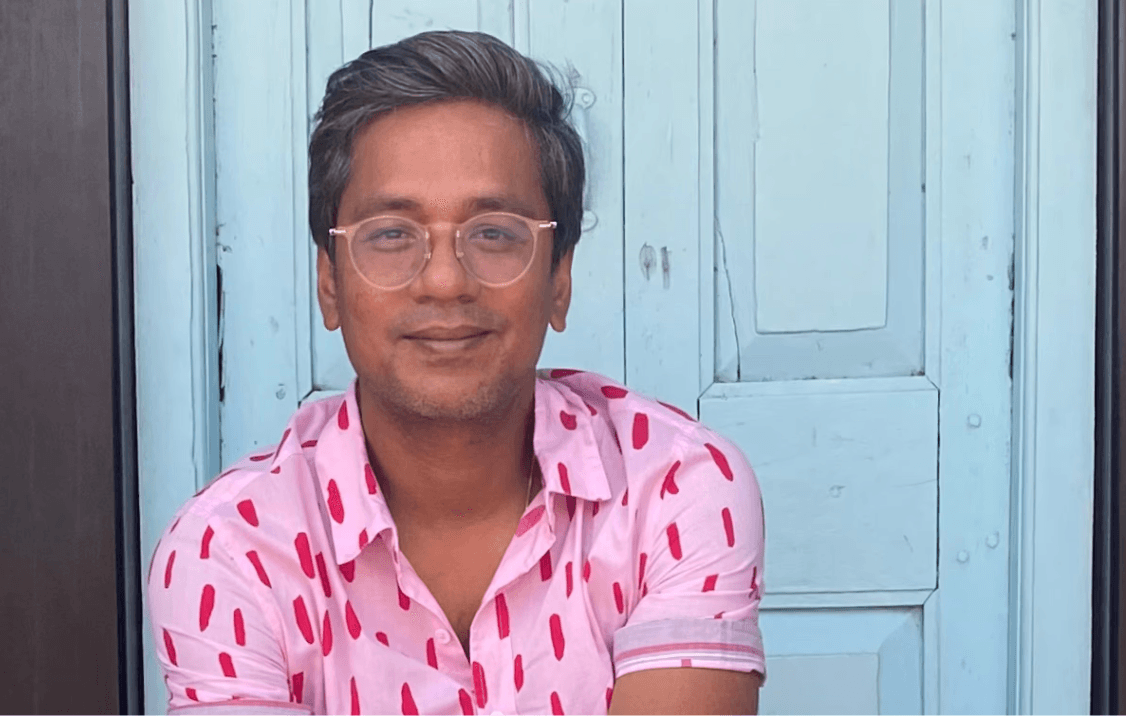 Woman working at desk with laptop and phone.