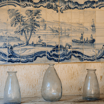 A couple of vases sitting on top of a shelf