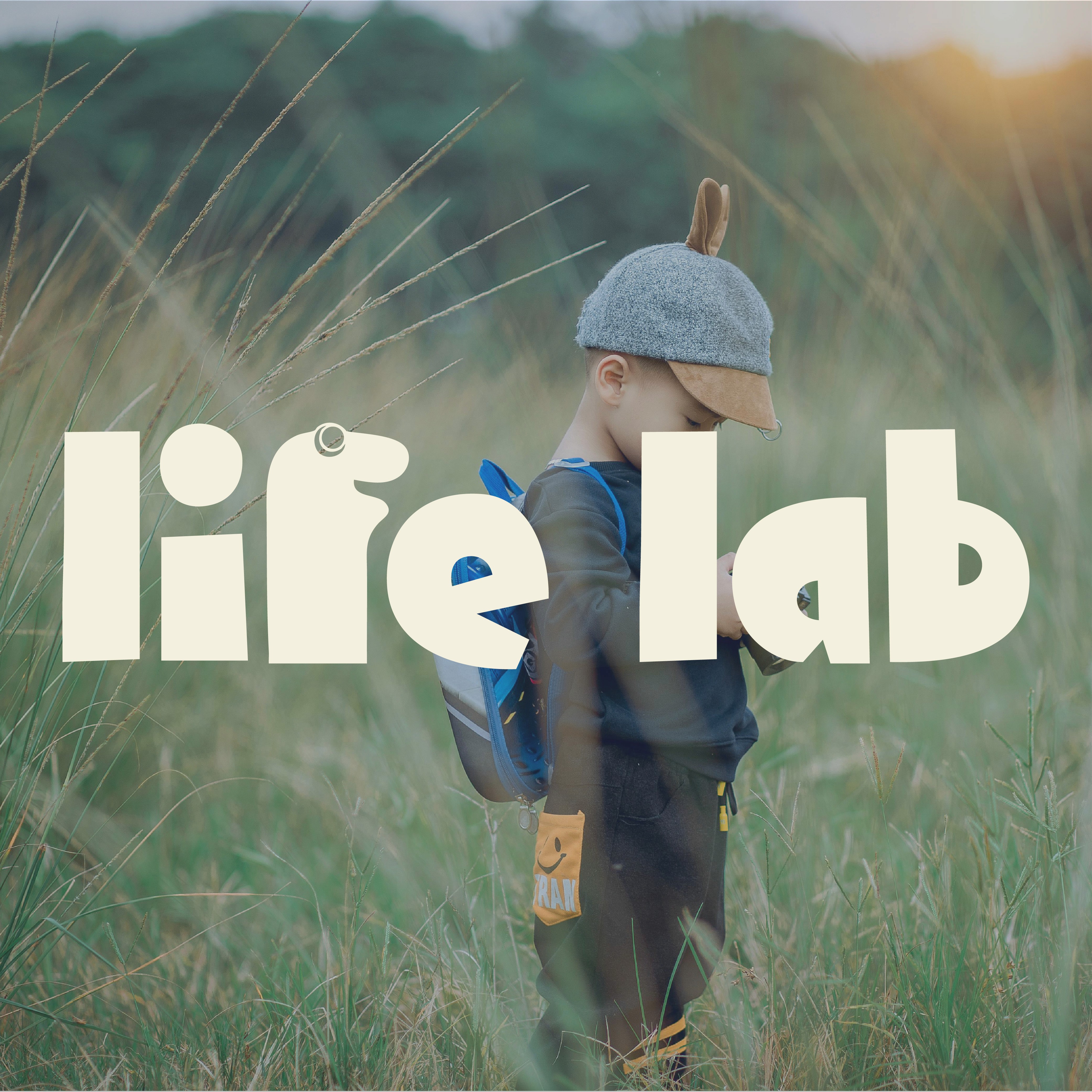 Wellness brand life lab logo layered over image of child exploring the outdoors