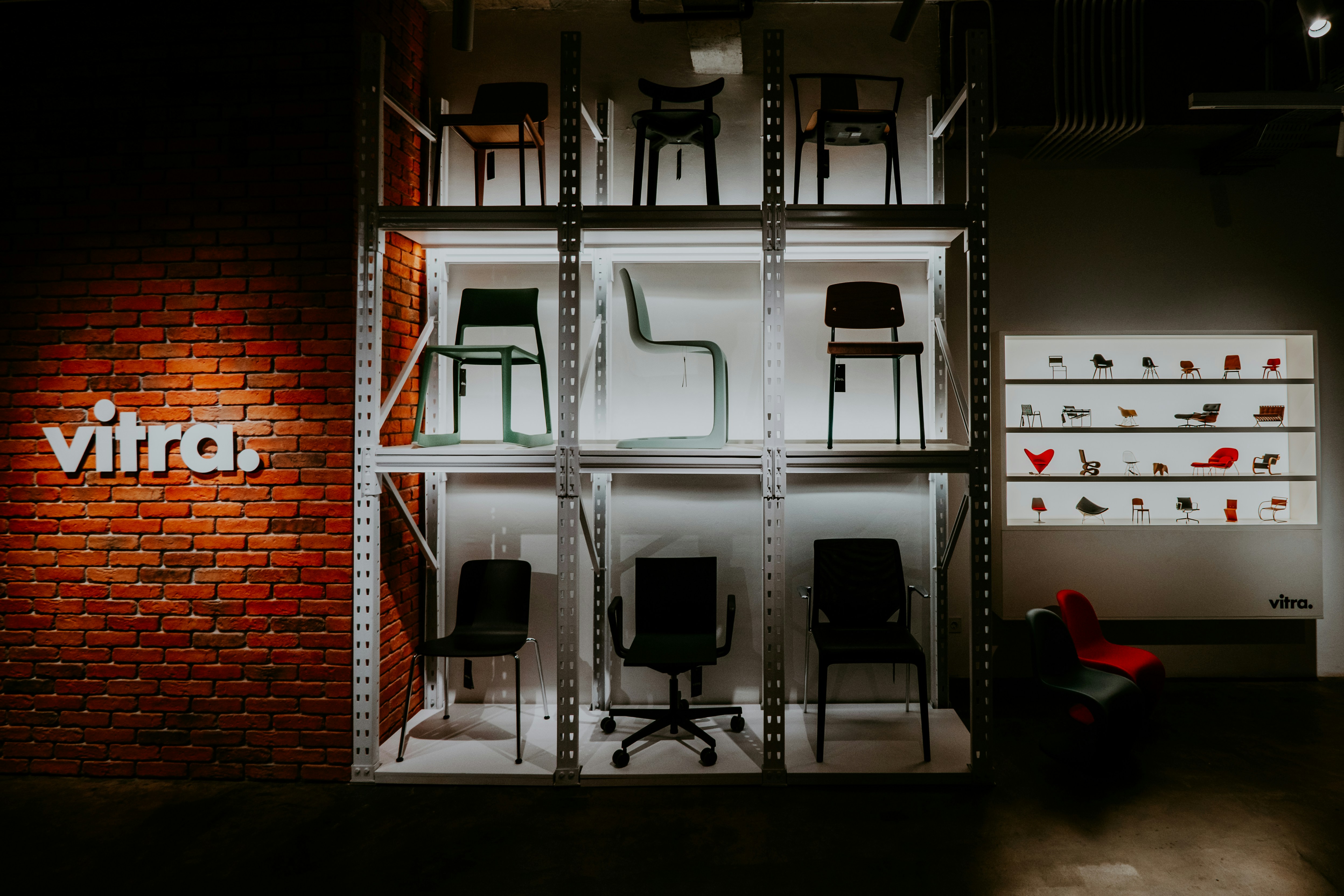 a room with a brick wall and a display of chairs