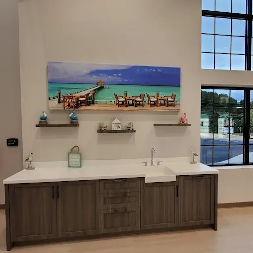 Modern sink area with artwork on the wall