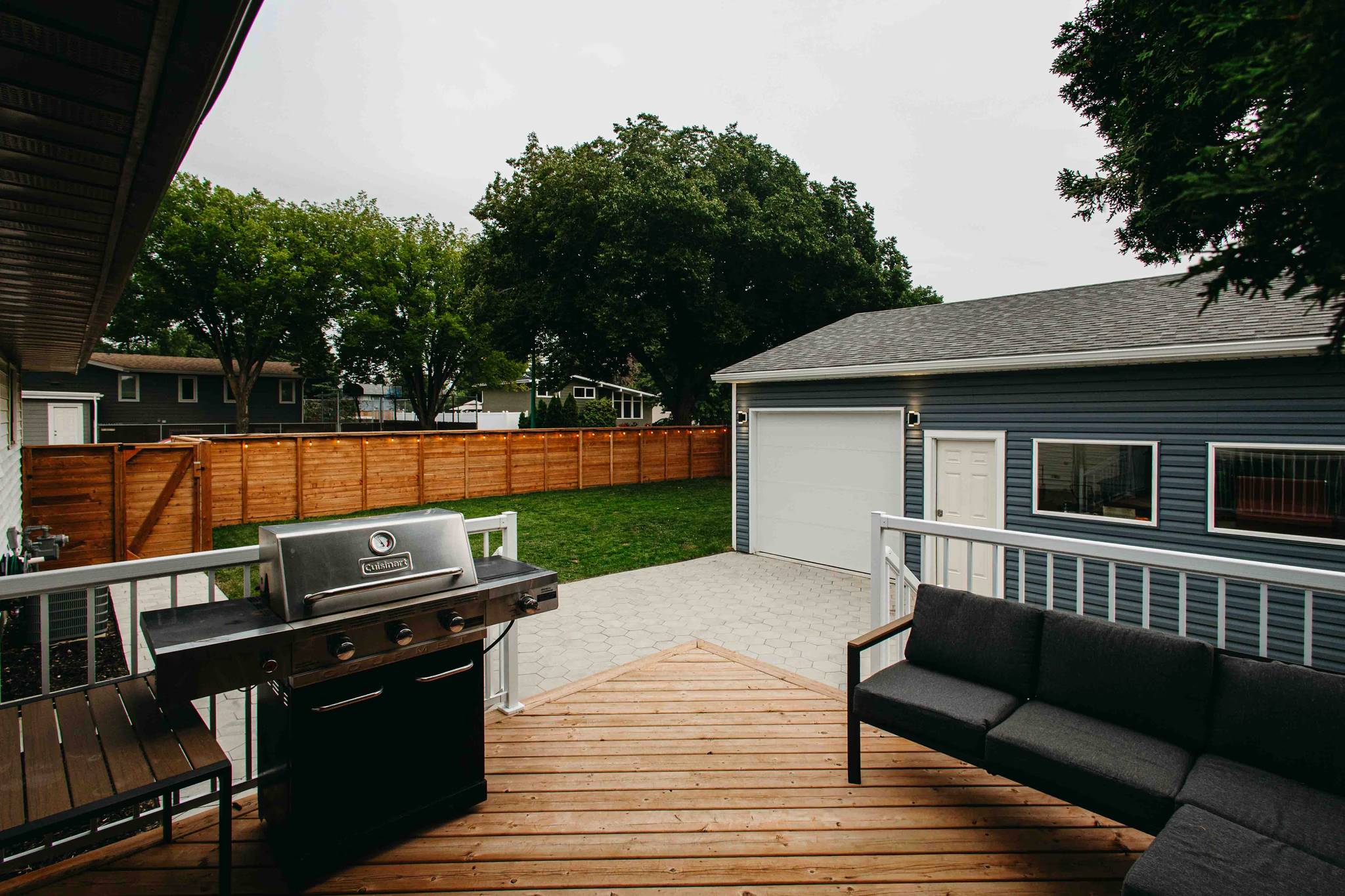 A Saskatoon backyard after renovation showcasing custom patio and garage