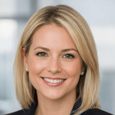 man wearing blue polo shirt with building background