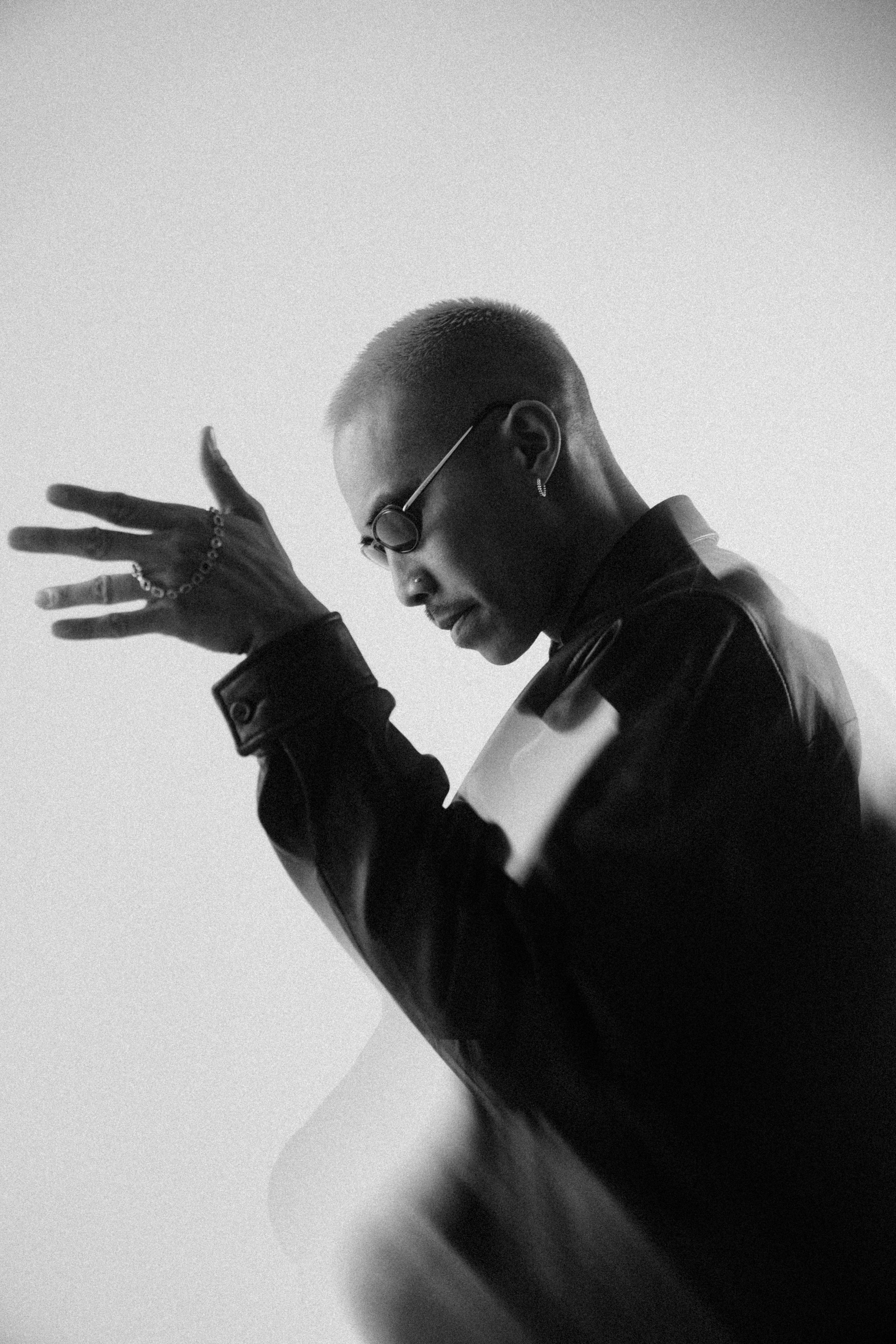 Black and white portrait of a man in a suit with dramatic hand gesture, editorial photography for Pharmapro project by Softic Studio