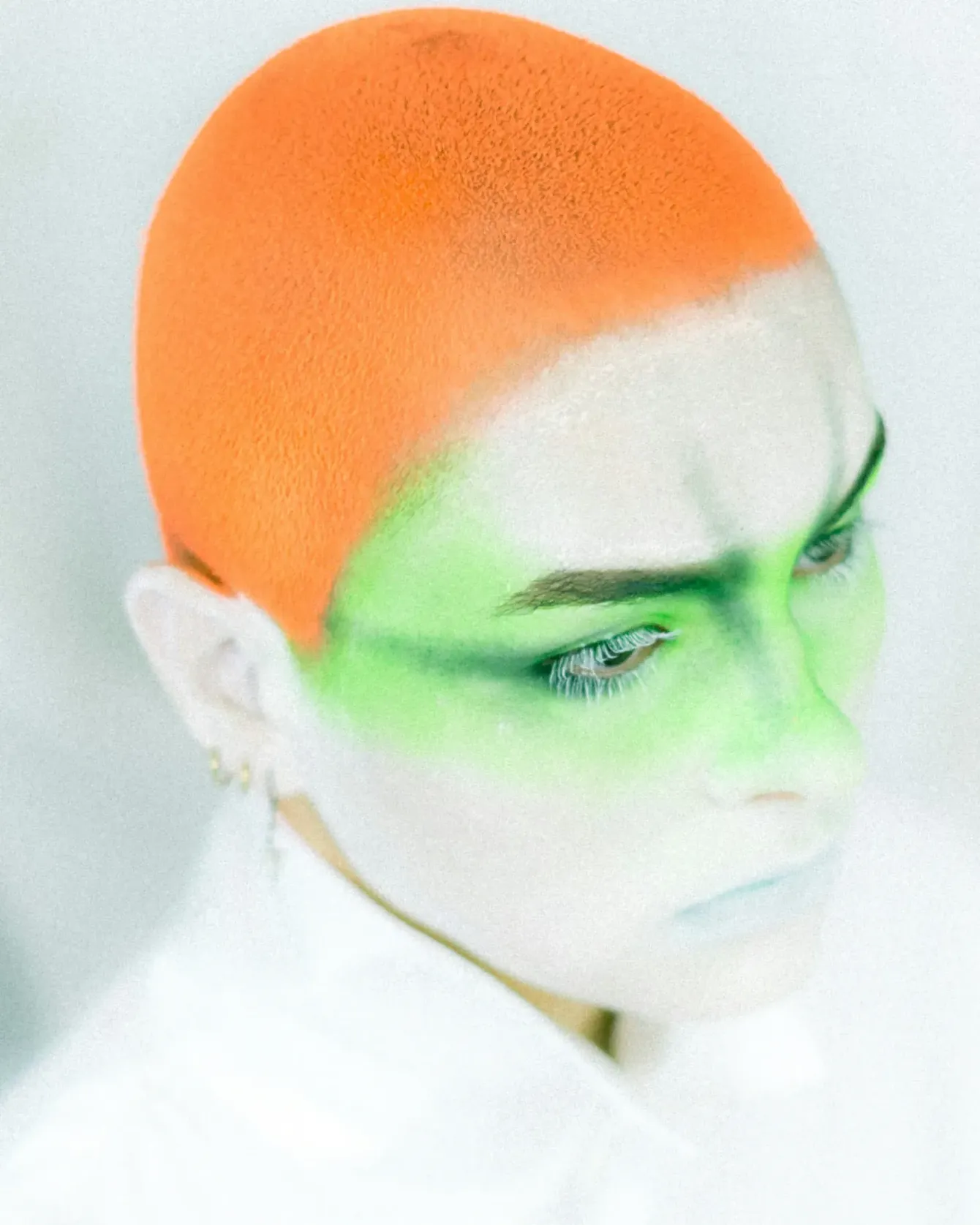 a person with a green face and a white background