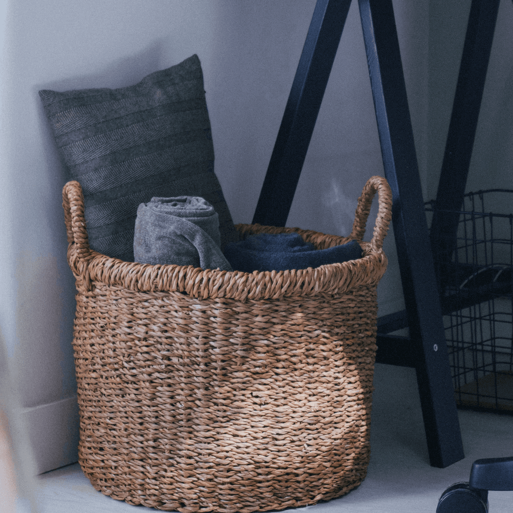 a basket sitting next to a computer on top of a desk