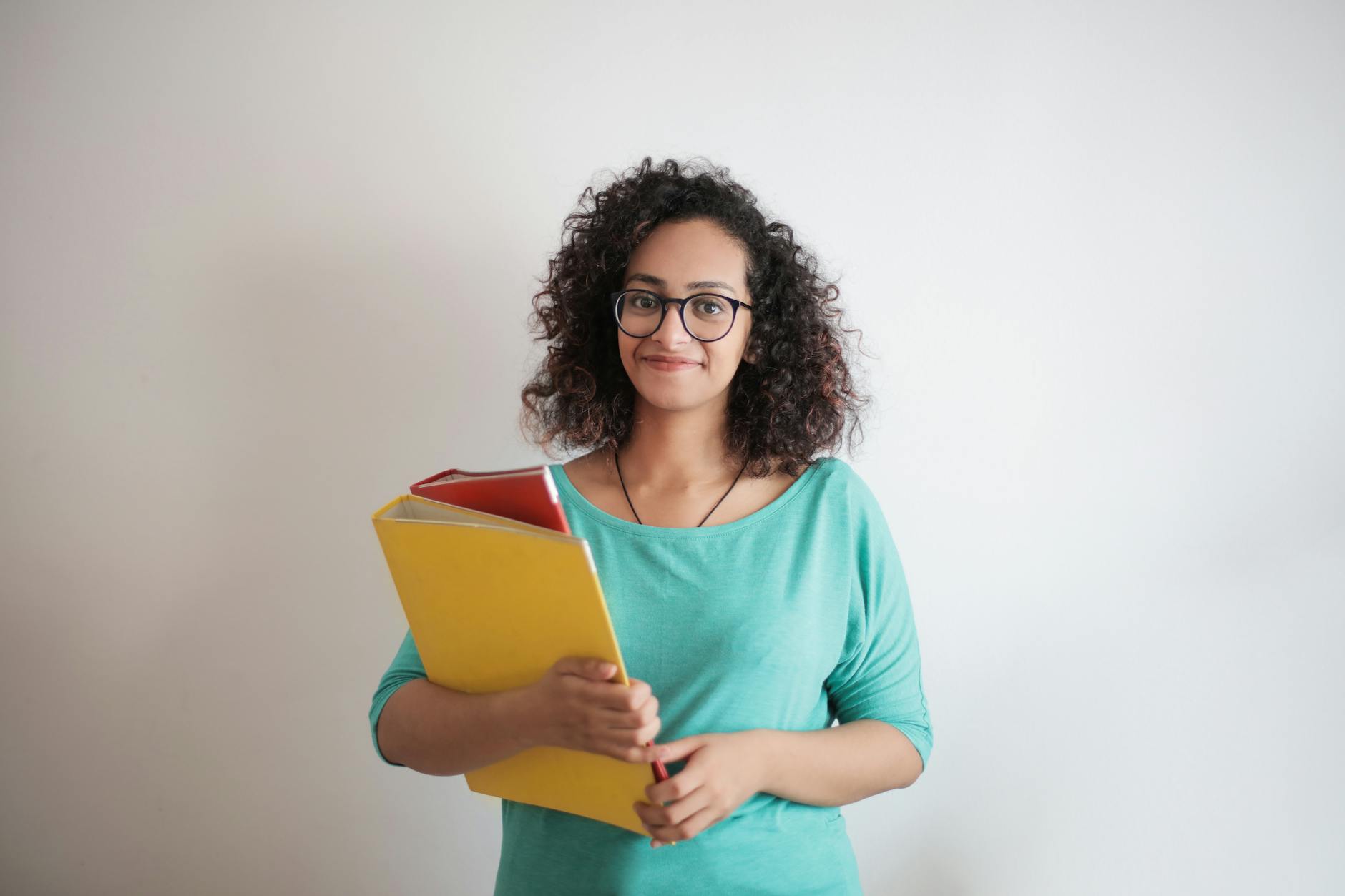 An educator comparing different grade-level curriculum binders and social emotional learning activities.