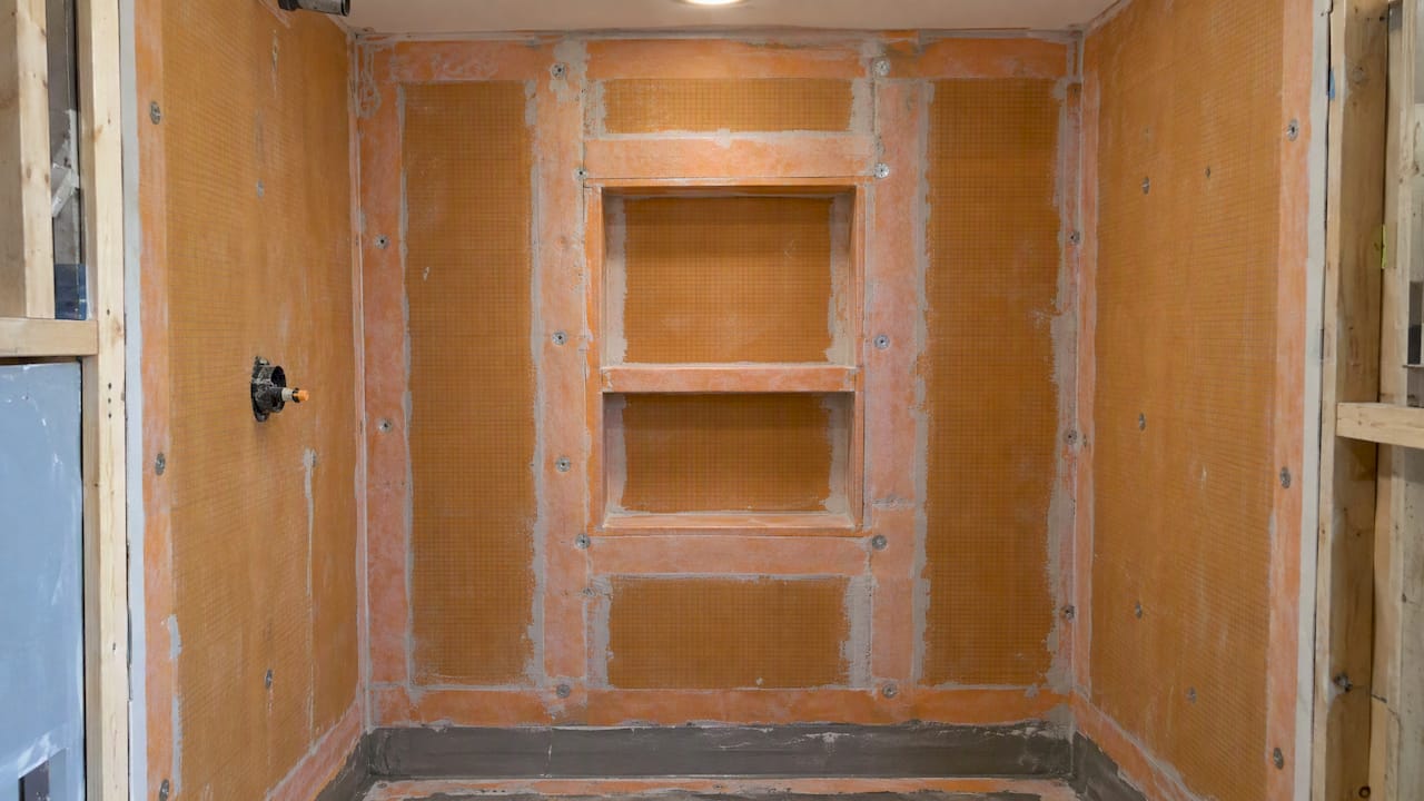 Waterproofed shower niche with treated seams