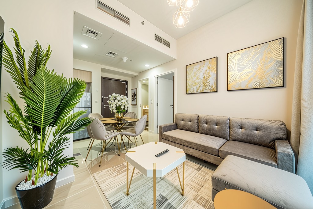 A modern apartment featuring a stylish living room and dining area, designed for comfort and elegance.