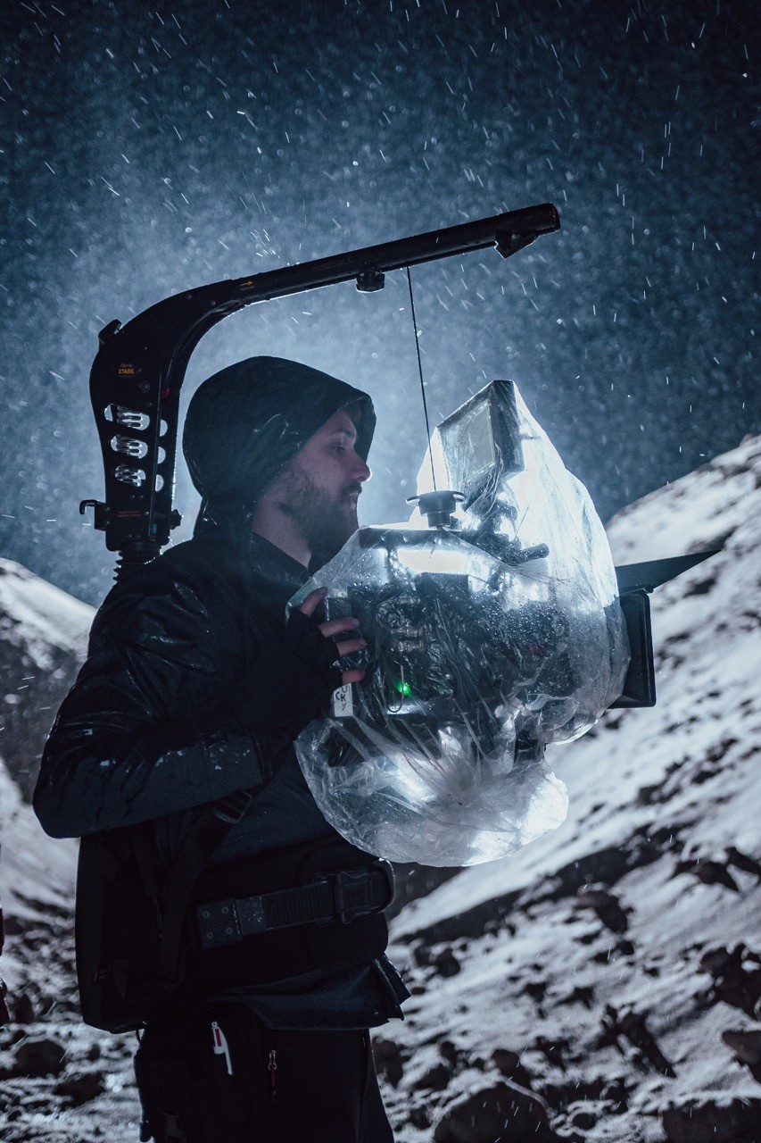 Stokedhouse videographer capturing the night magic in a snowy mountain wilderness