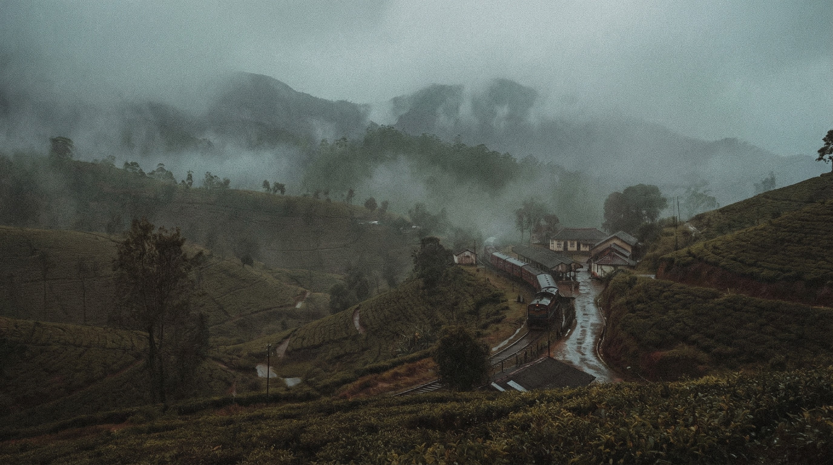 a couple of people standing on top of a mountain