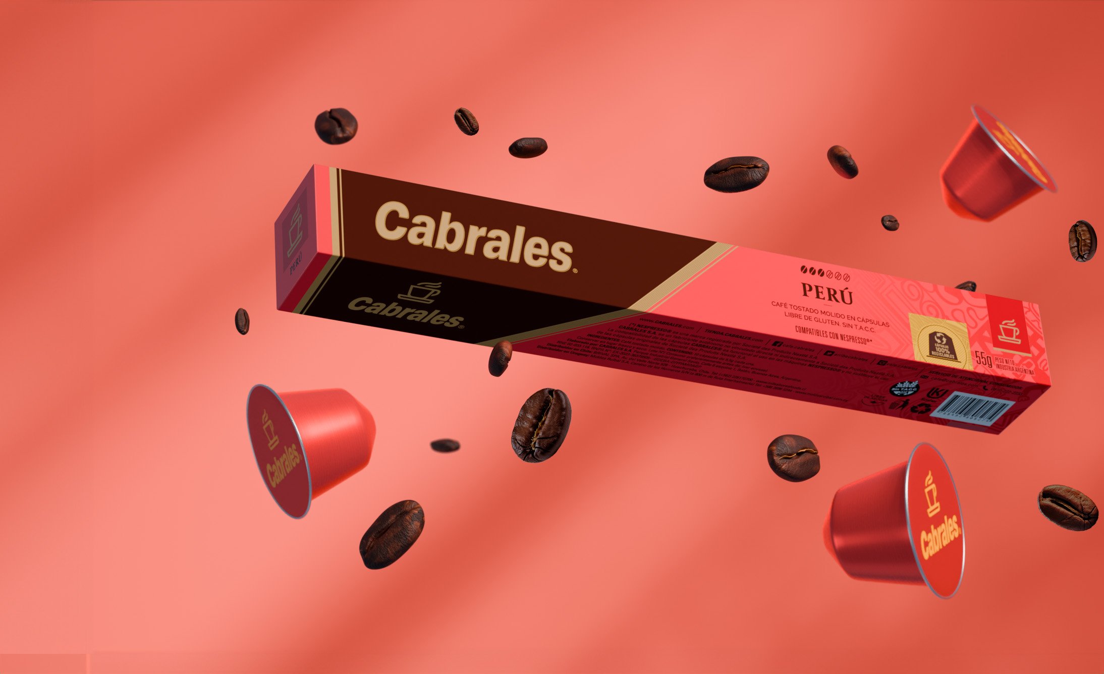 Floating red coffee capsules, whole coffee beans, and a box labeled "Cabrales Perú" on a matching red background, conveying a vibrant, dynamic energy.
