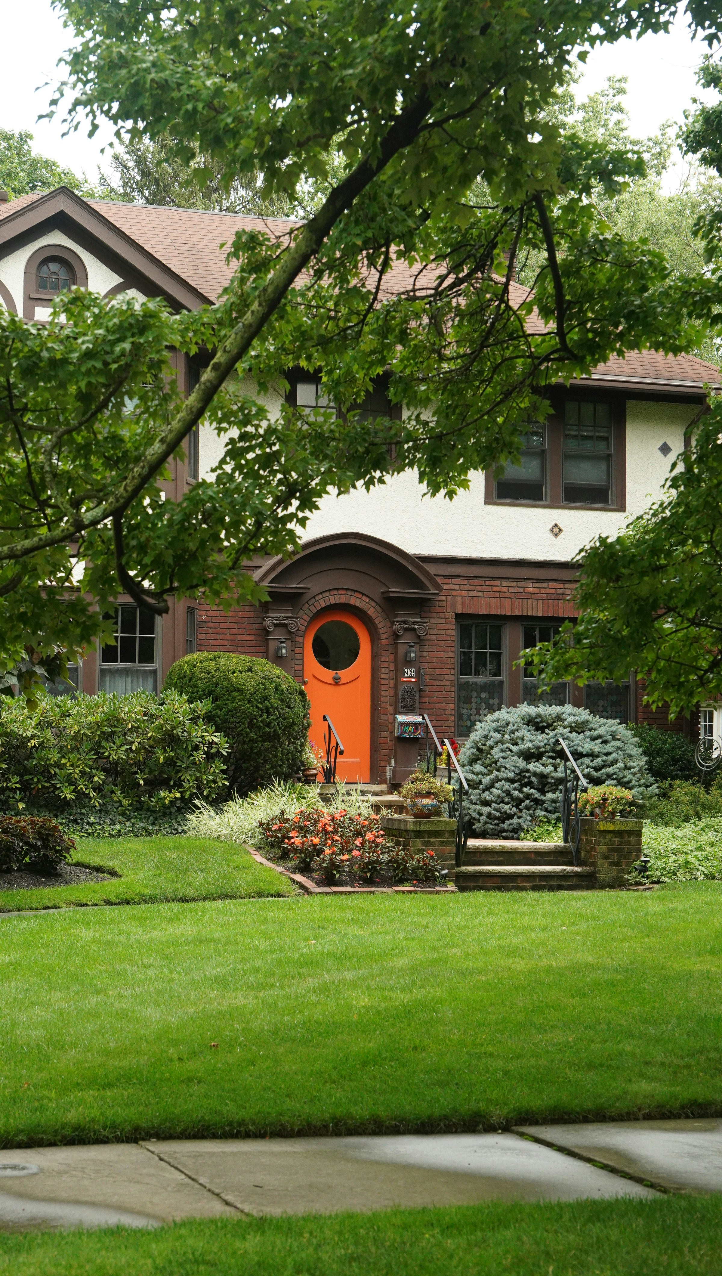 A house with a red door and a green lawn